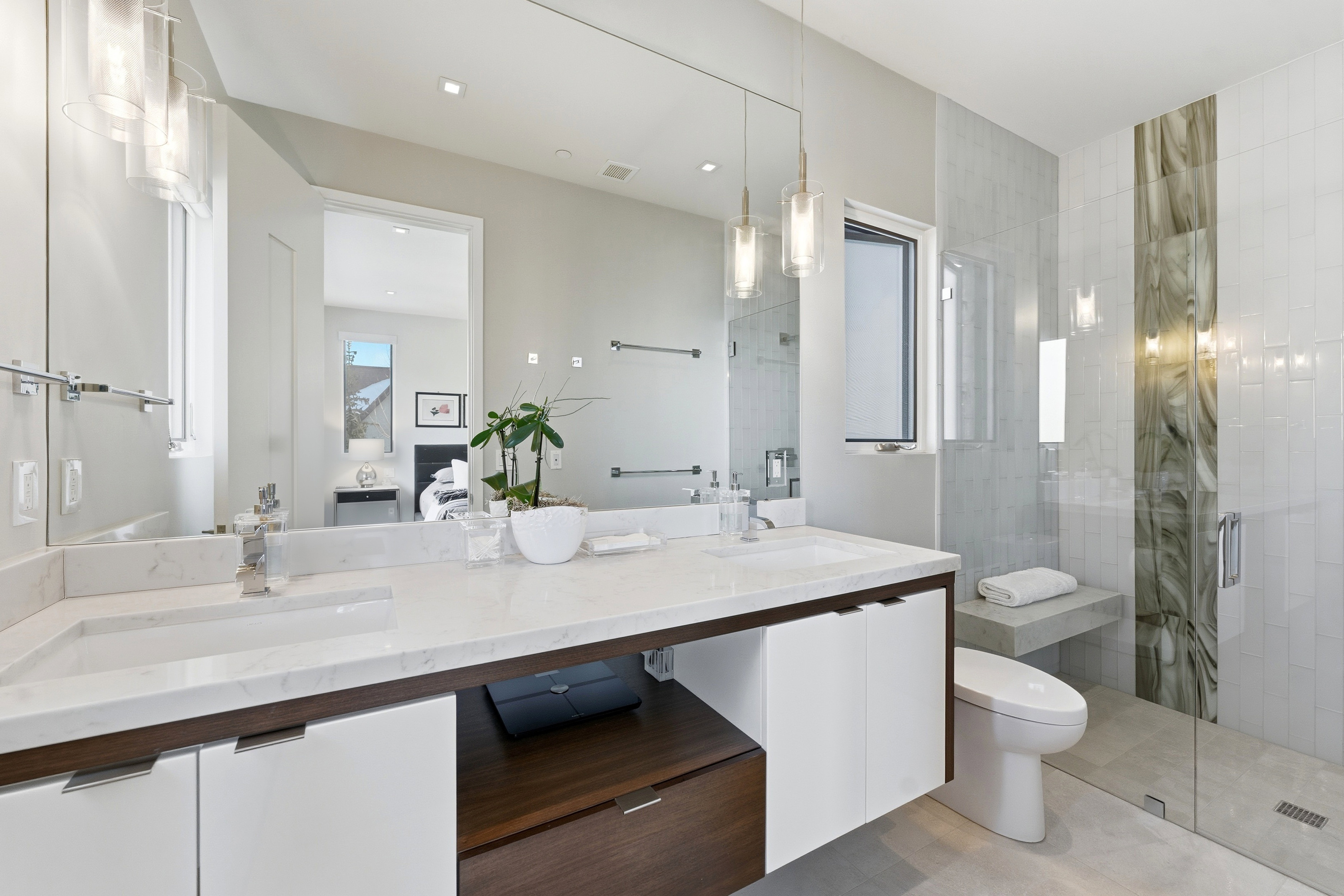 Double vanity with integrated sinks and white countertops