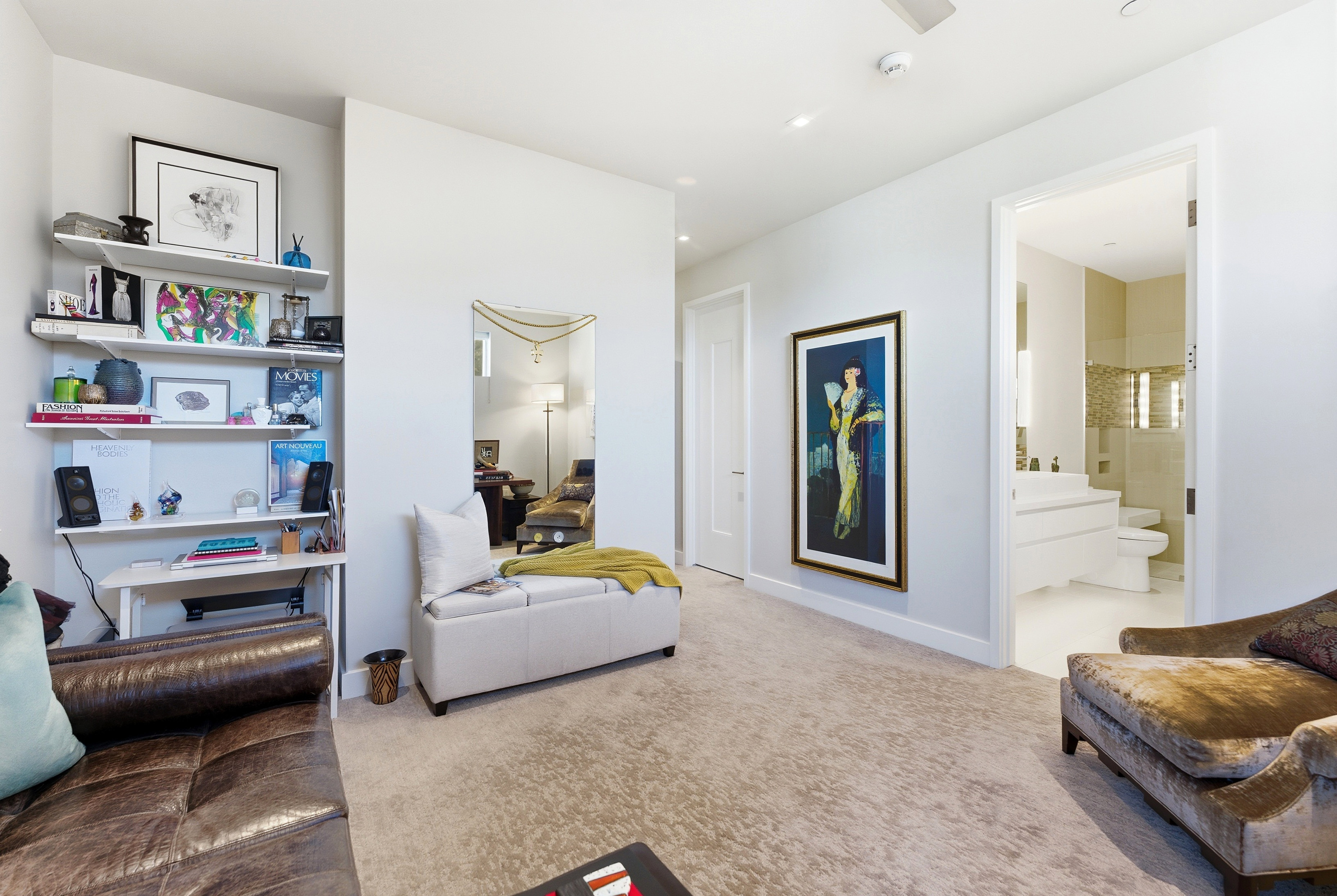Plush carpeting throughout this interior space, featuring a built-in shelving unit, a neutral color palette, a doorway to an additional room, and a ceiling-mounted smoke detector