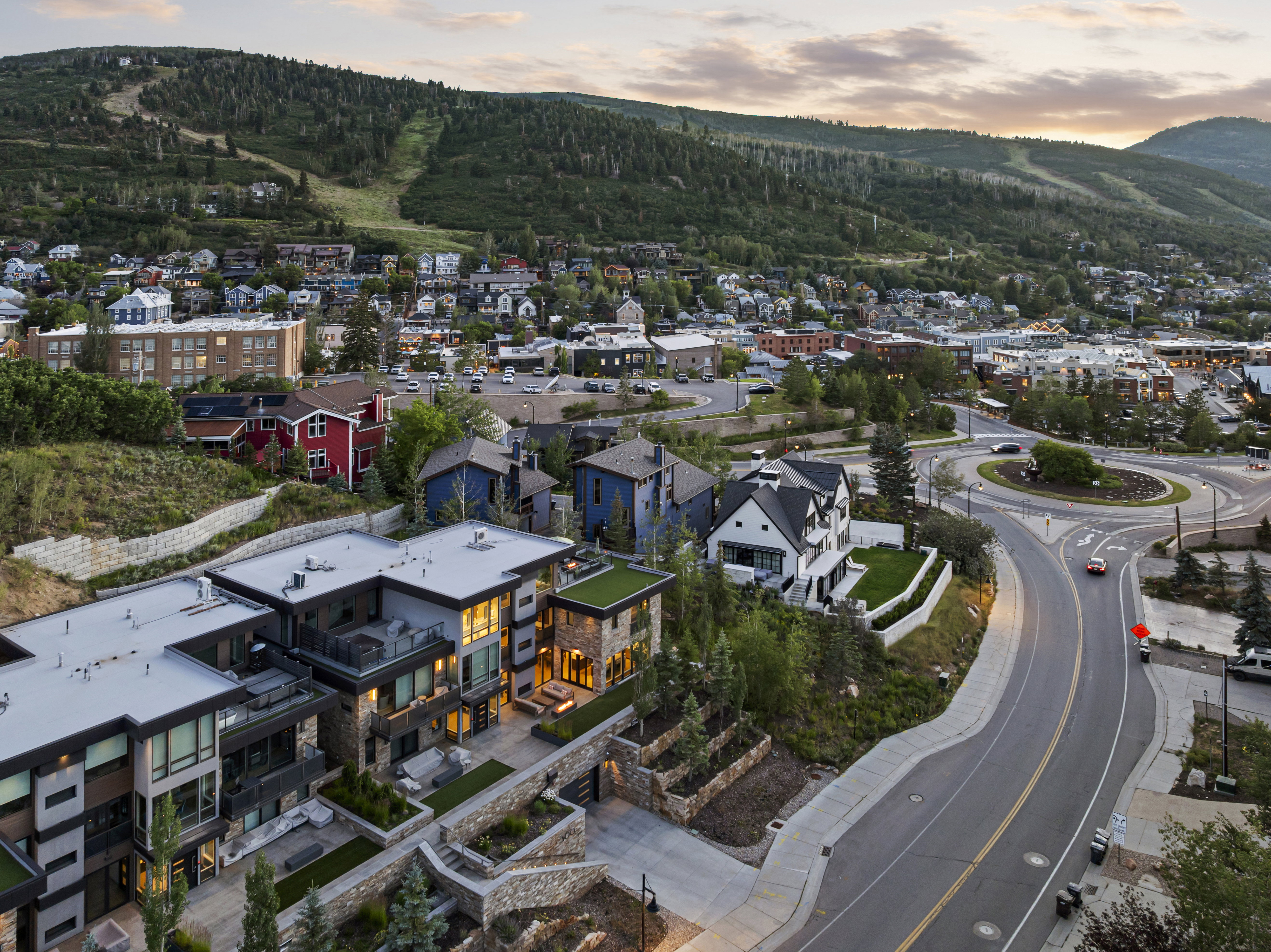 Contemporary multi-level residences featuring flat roofs, multiple balconies, and stone retaining walls