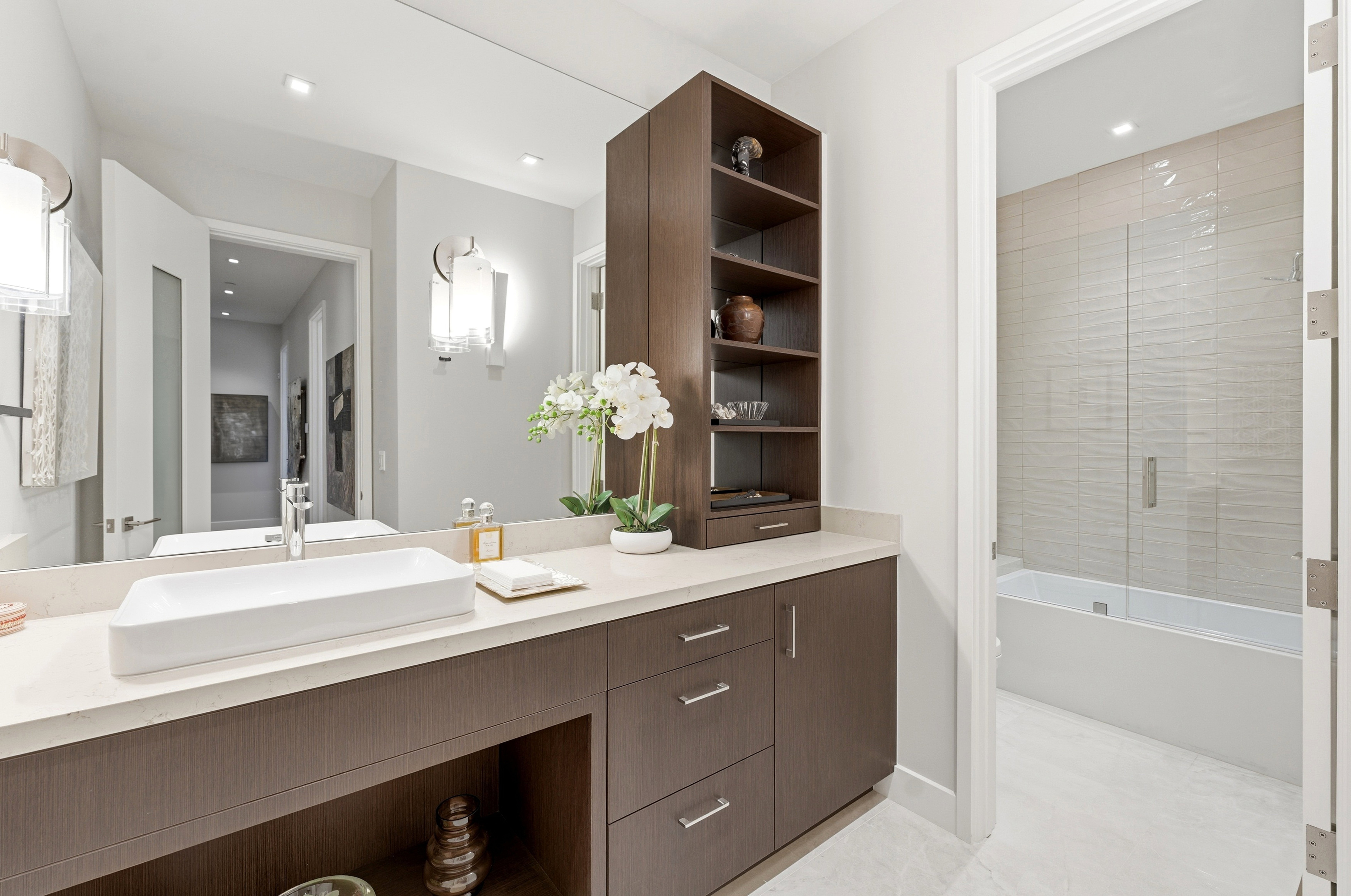 Bathroom vanity featuring a rectangular vessel sink, polished chrome faucet, full-width mirror, and a light-toned countertop