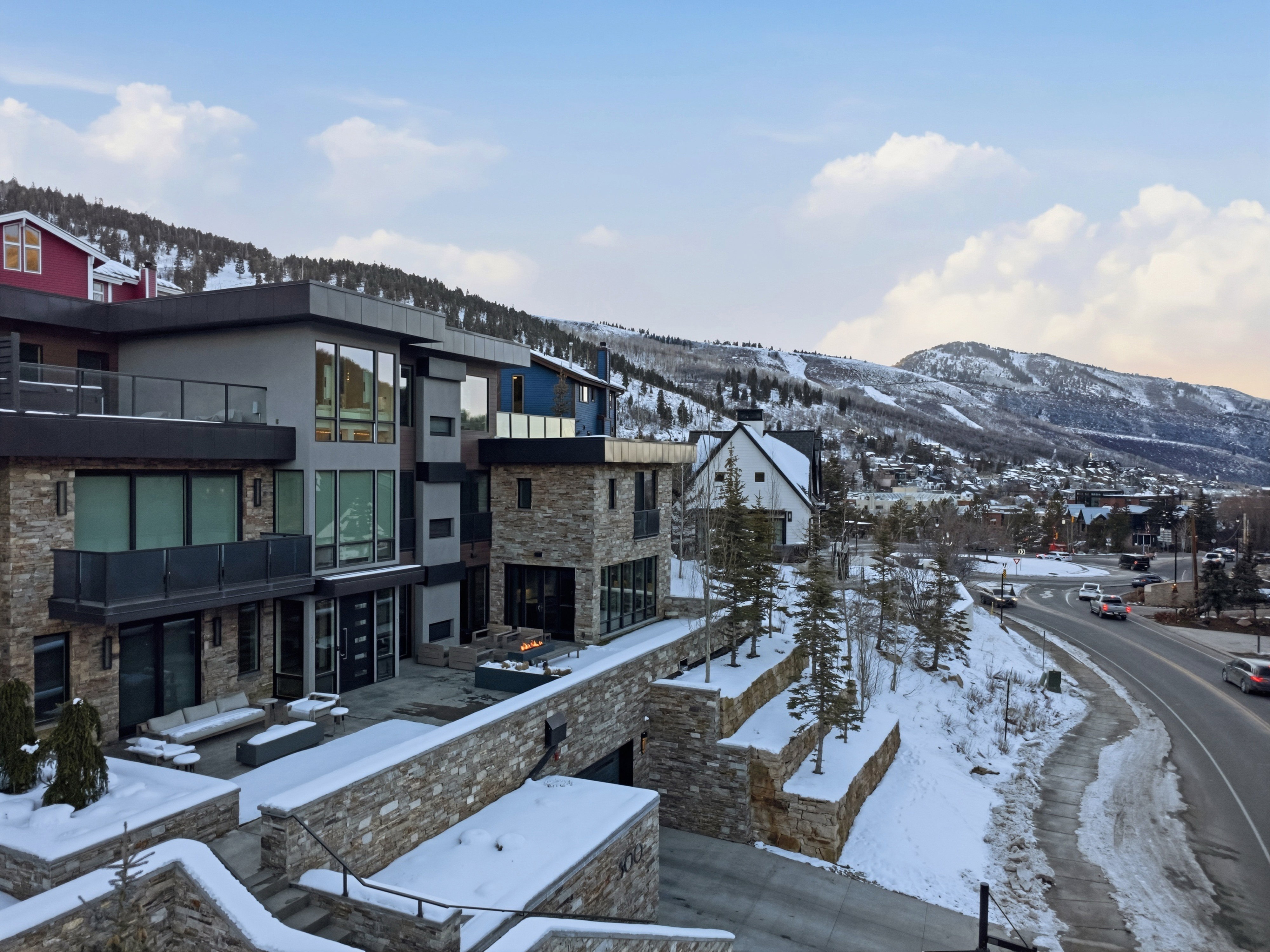 Modern multi-level residence featuring a stone and stucco exterior