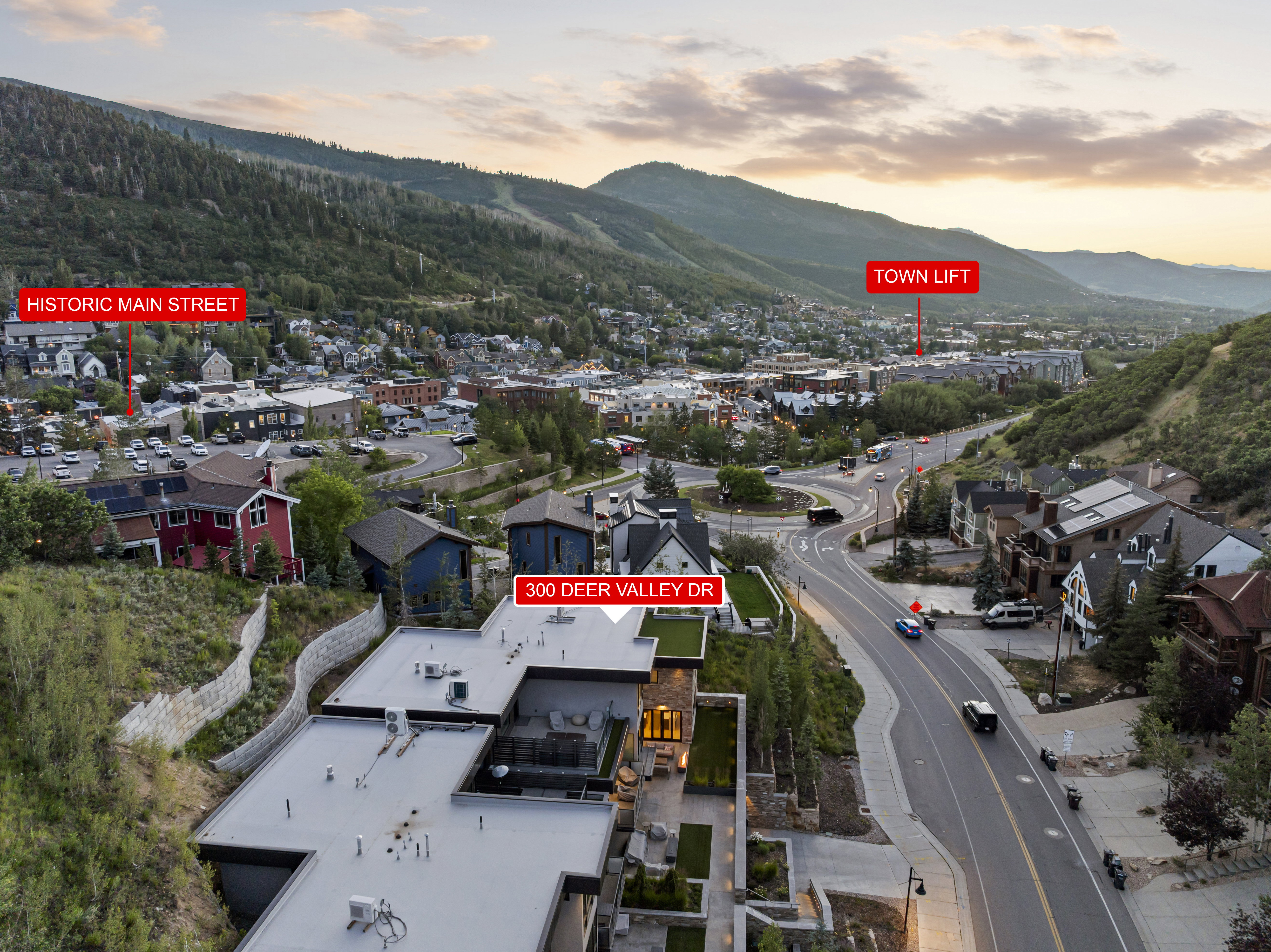 Aerial perspective showcasing the property's modern architecture with flat roofing and expansive outdoor patio areas