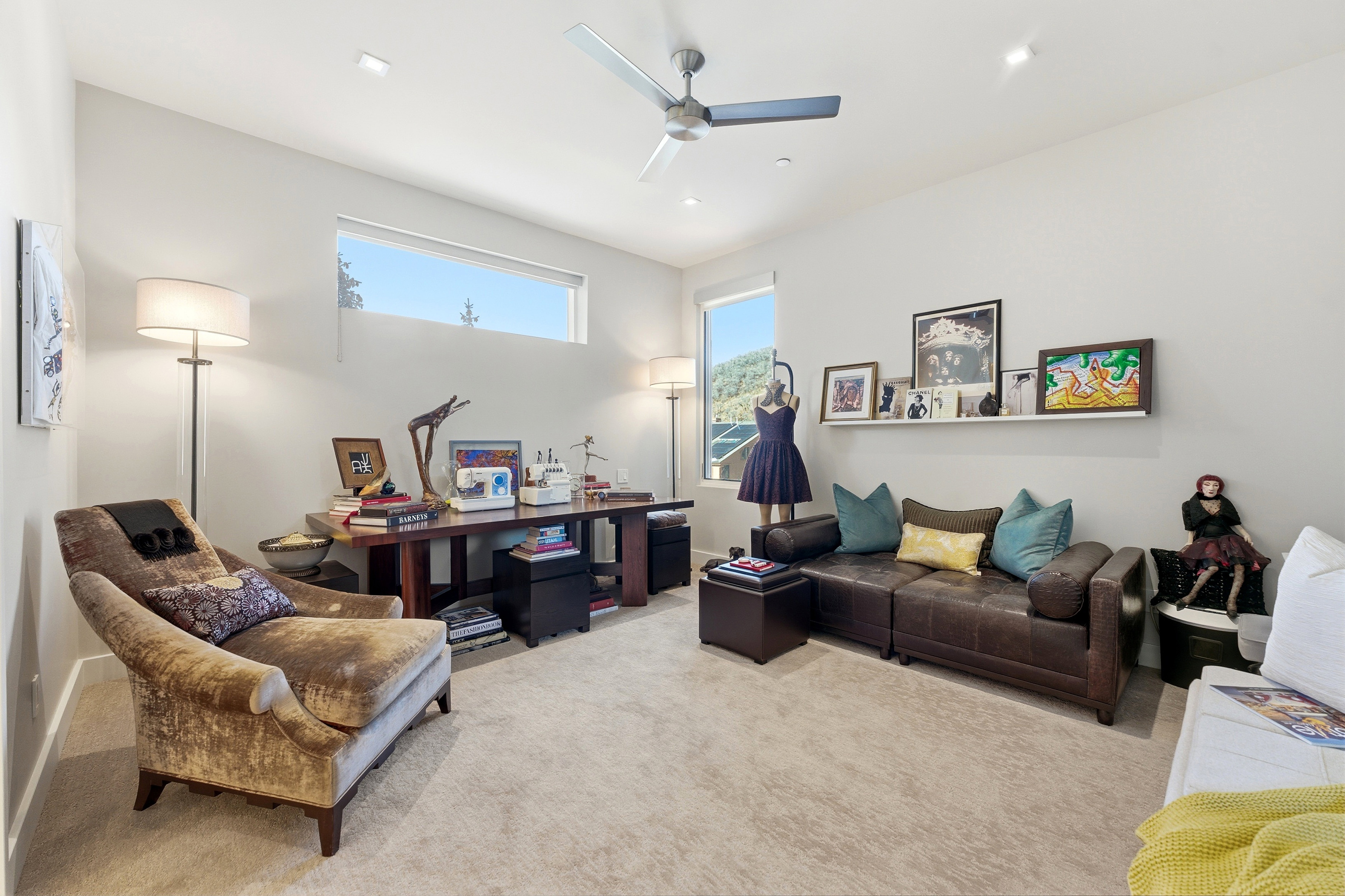 Spacious room featuring light-colored carpeting and high ceilings with recessed lighting