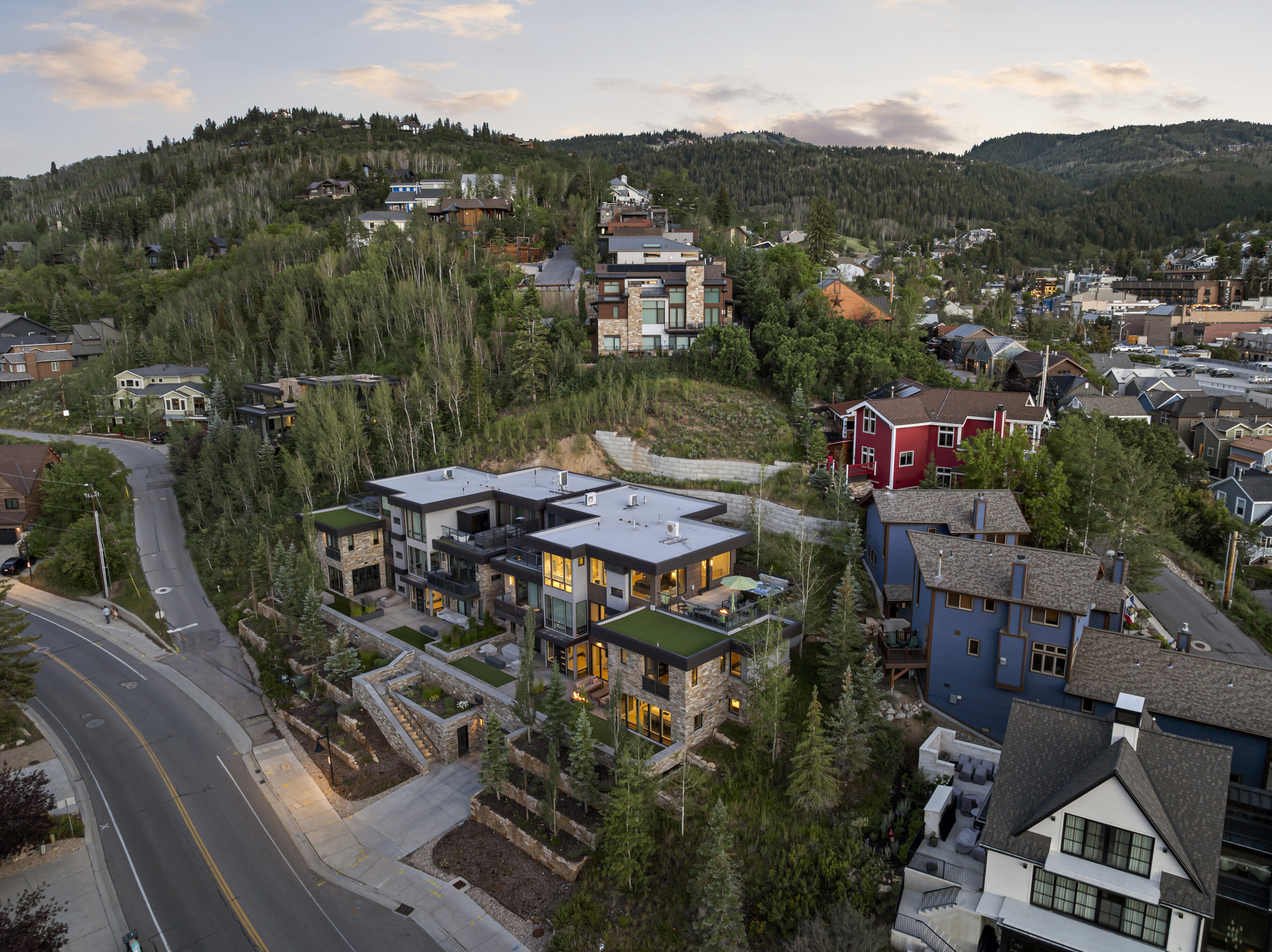 Contemporary multi-level structure featuring stone and stucco facade