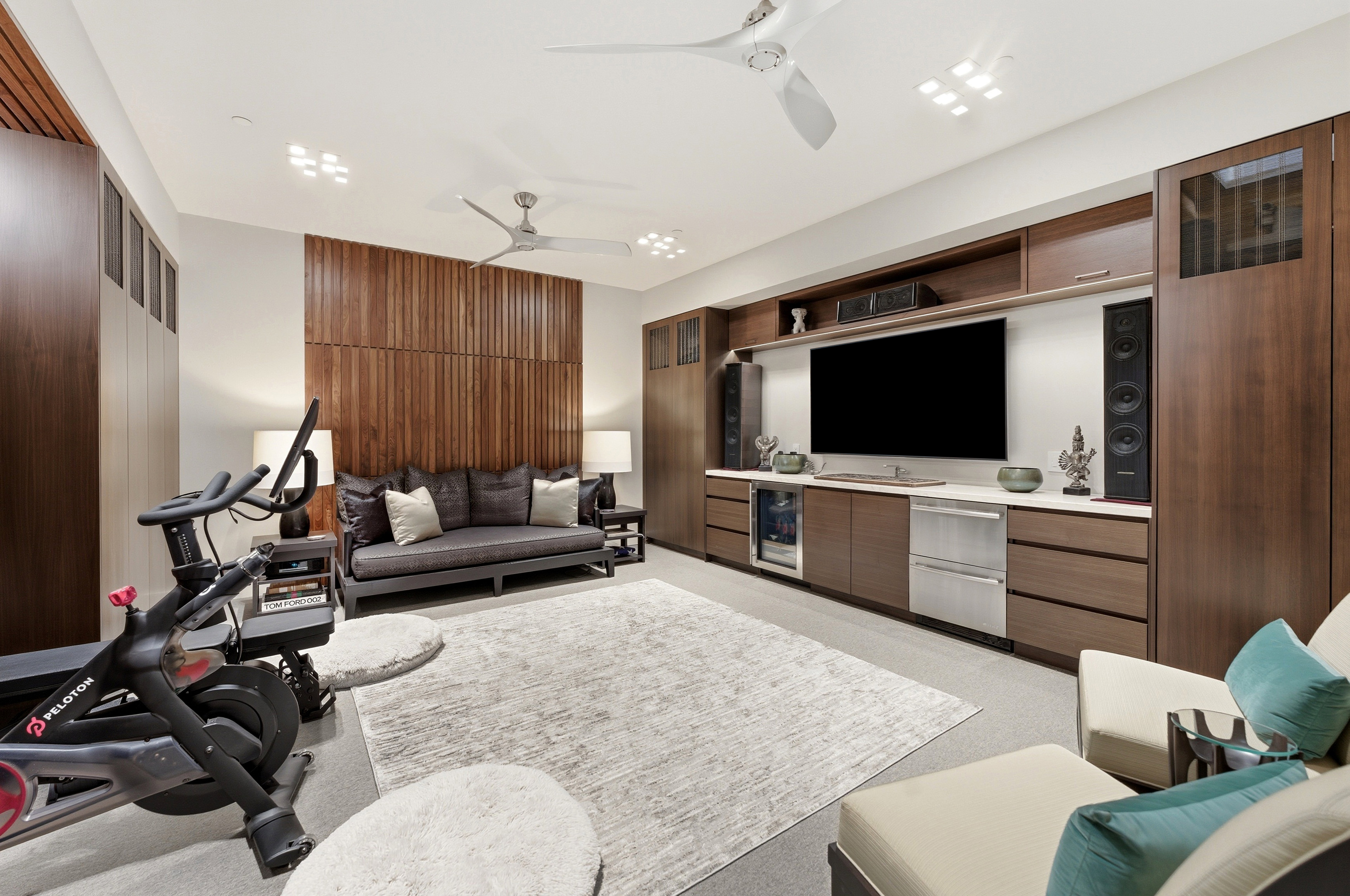 Integrated media wall featuring a large screen, built-in speakers, and multiple storage compartments