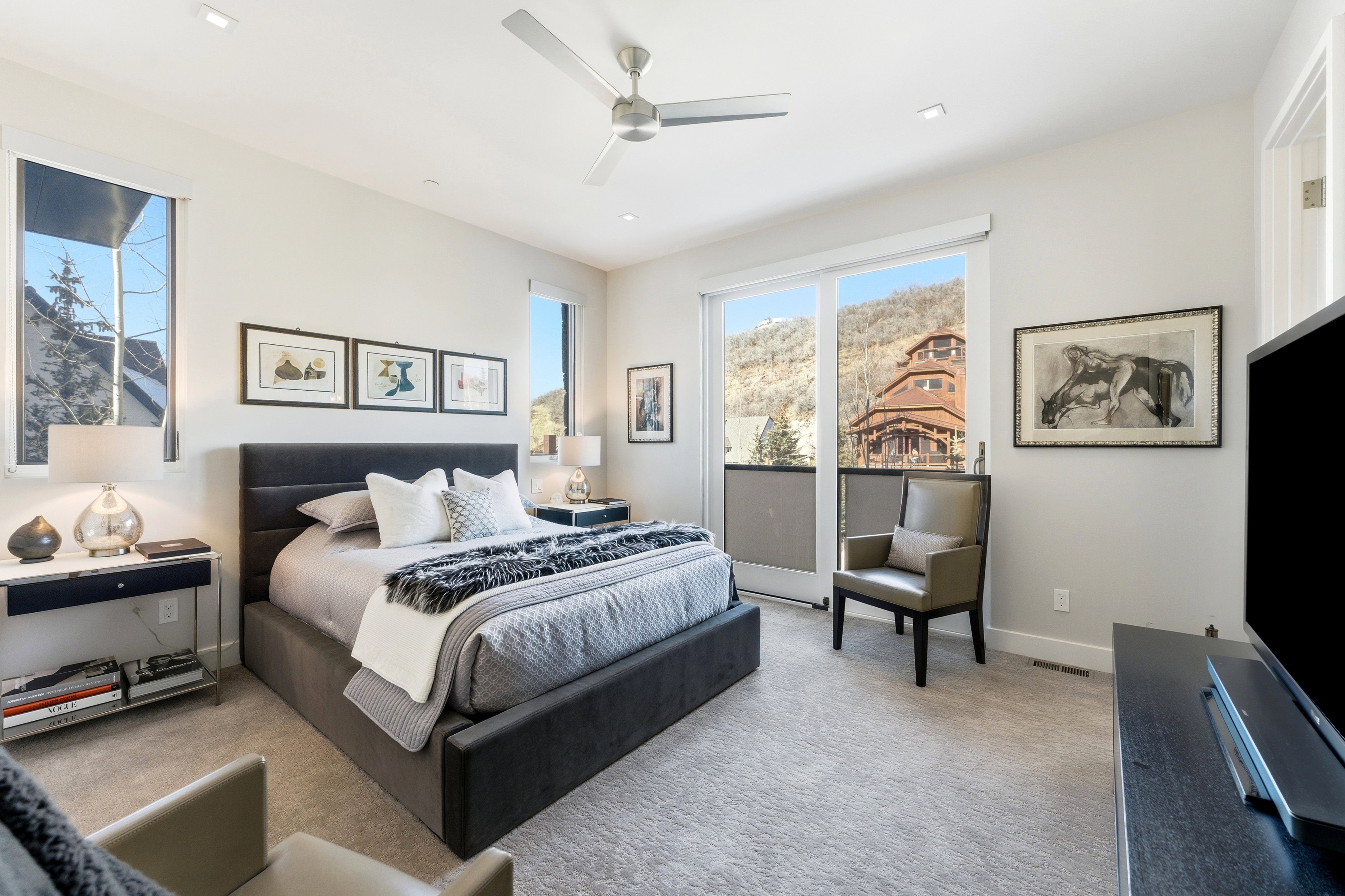 Carpeted bedroom with a built-in ceiling fan, recessed lighting, and a sliding glass door providing exterior access