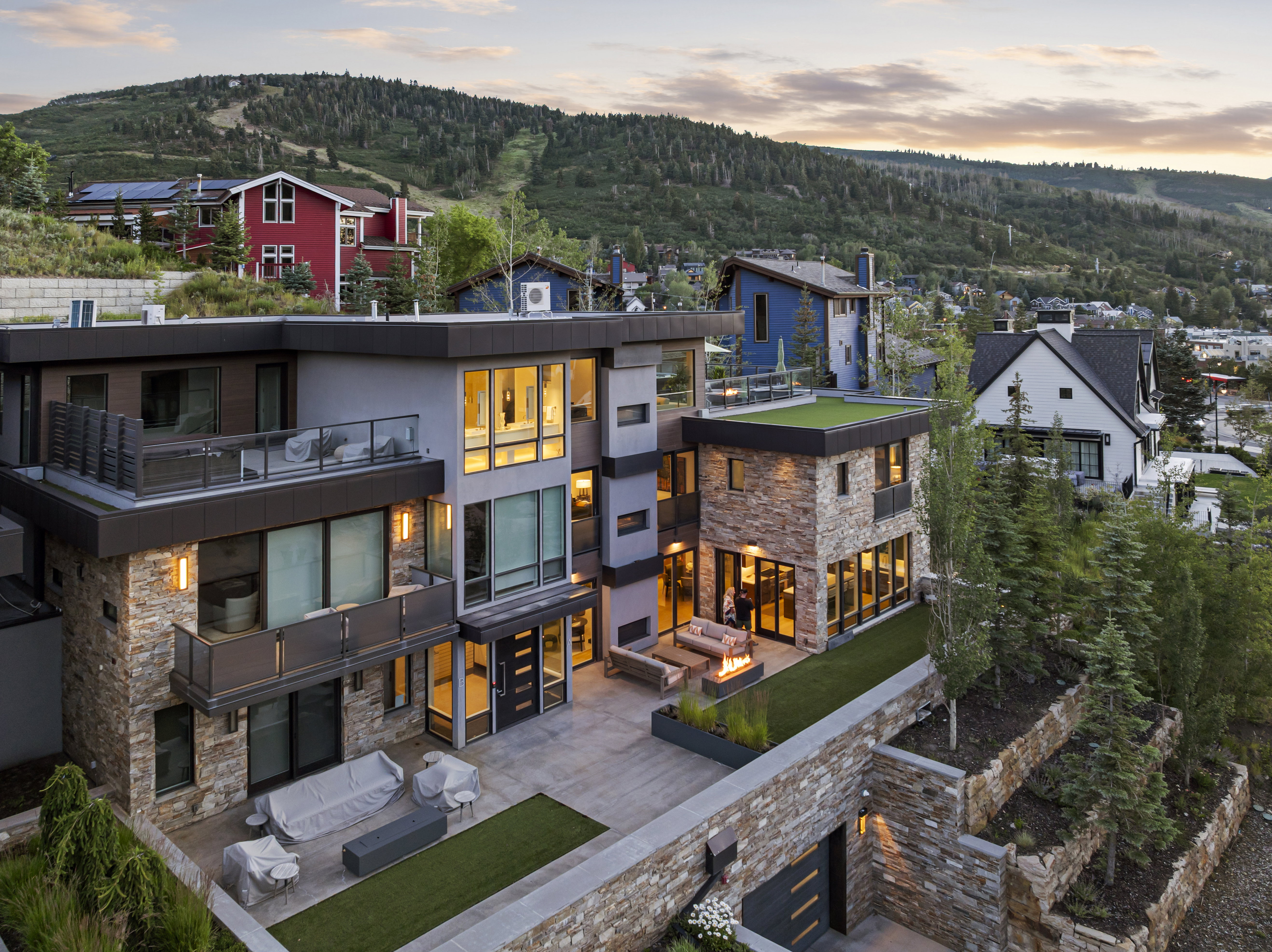 Modern multi-level residence featuring extensive stonework and large windows