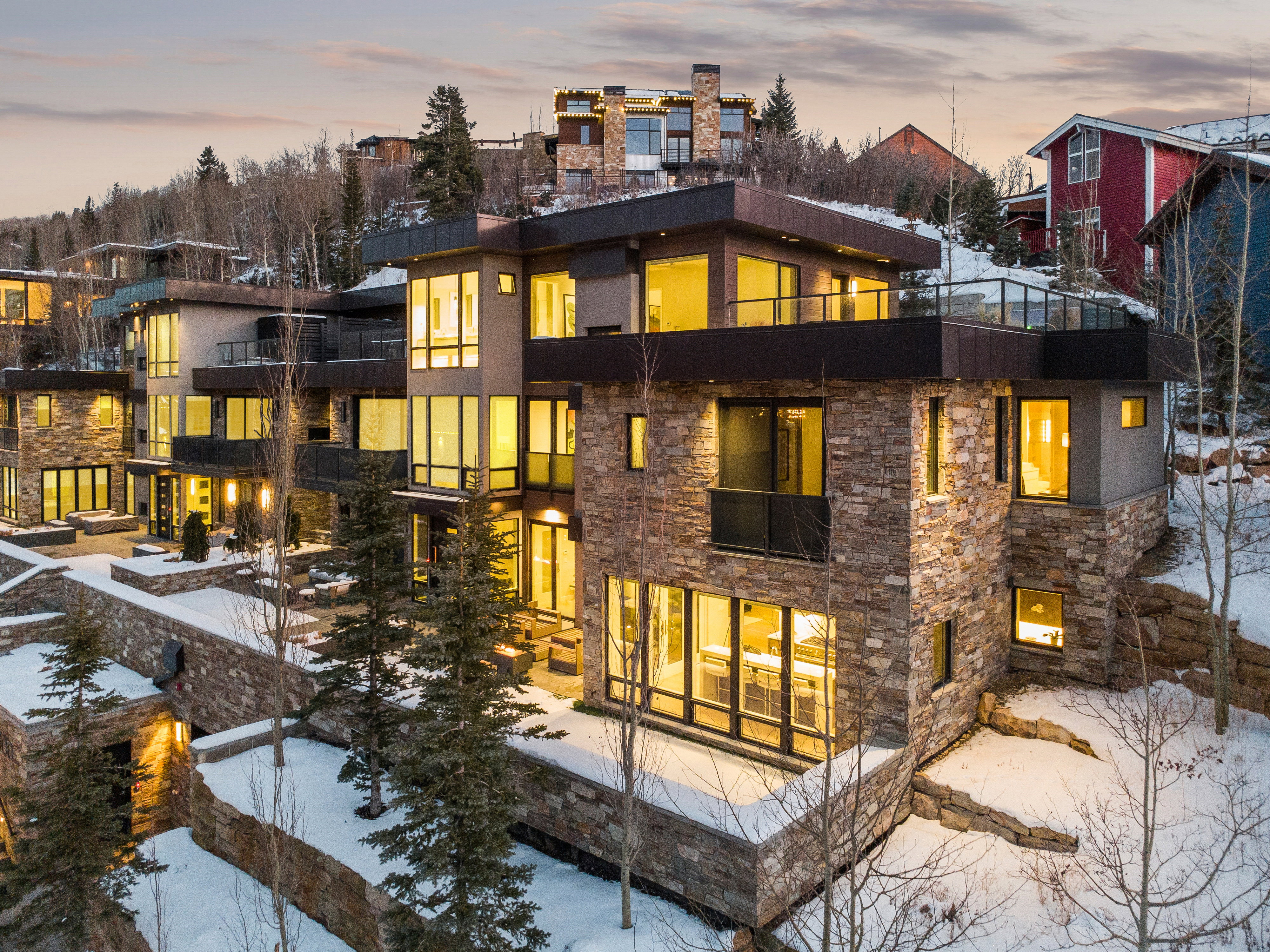 Contemporary multi-level residence featuring extensive stacked stone and stucco exterior finishes