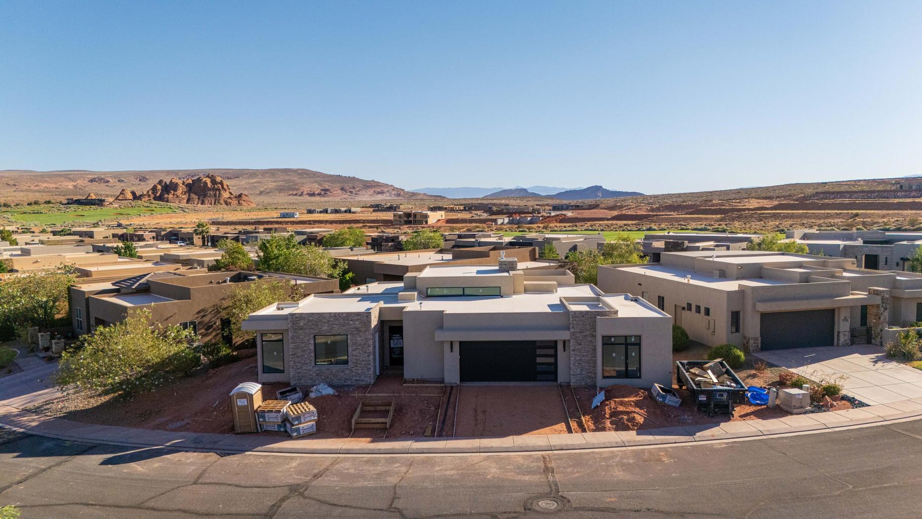 Contemporary single-story residence featuring a flat roofline and integrated garage