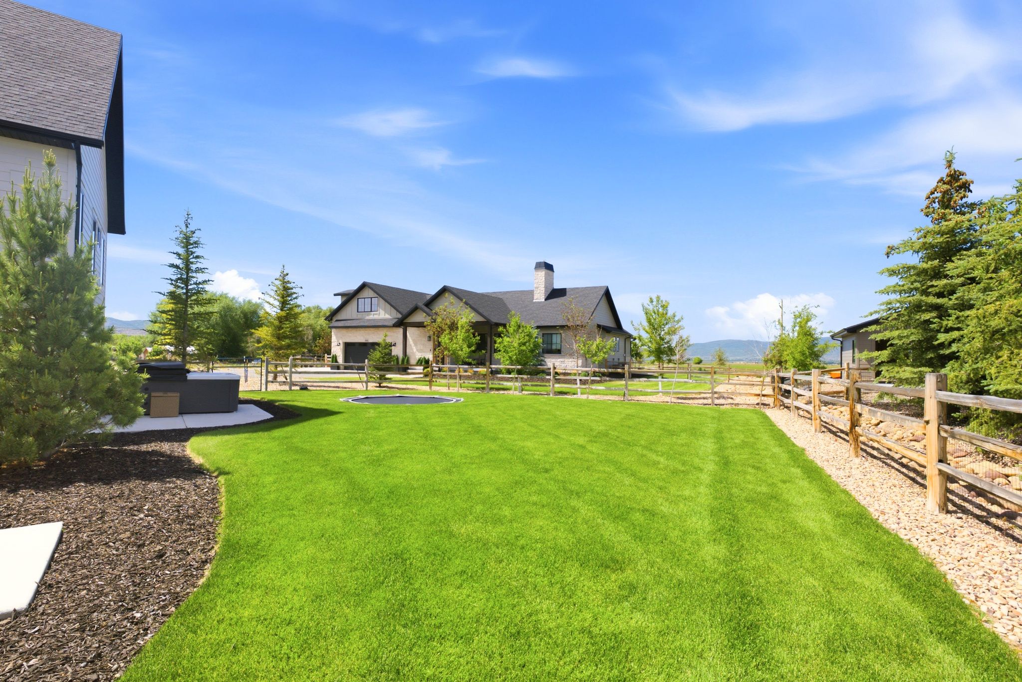Expansive manicured lawn with an in-ground trampoline