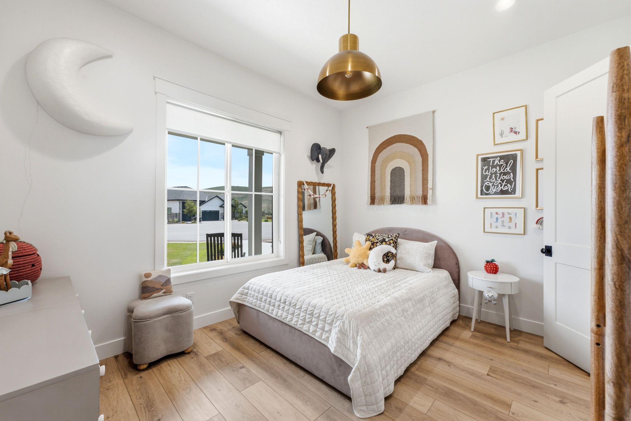 Bright bedroom featuring a large window, recessed lighting, and wood-finish flooring