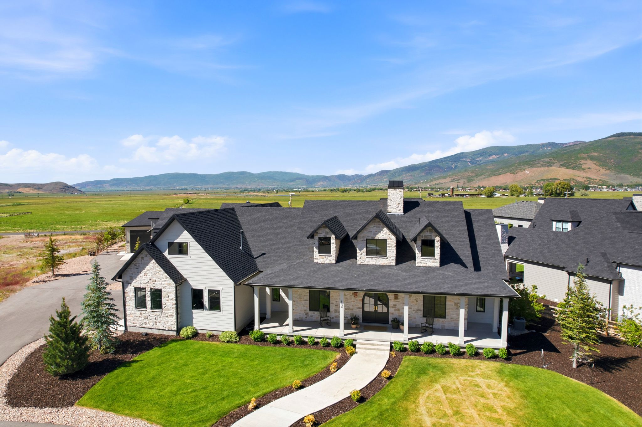 Contemporary farmhouse architecture with stone and siding exterior