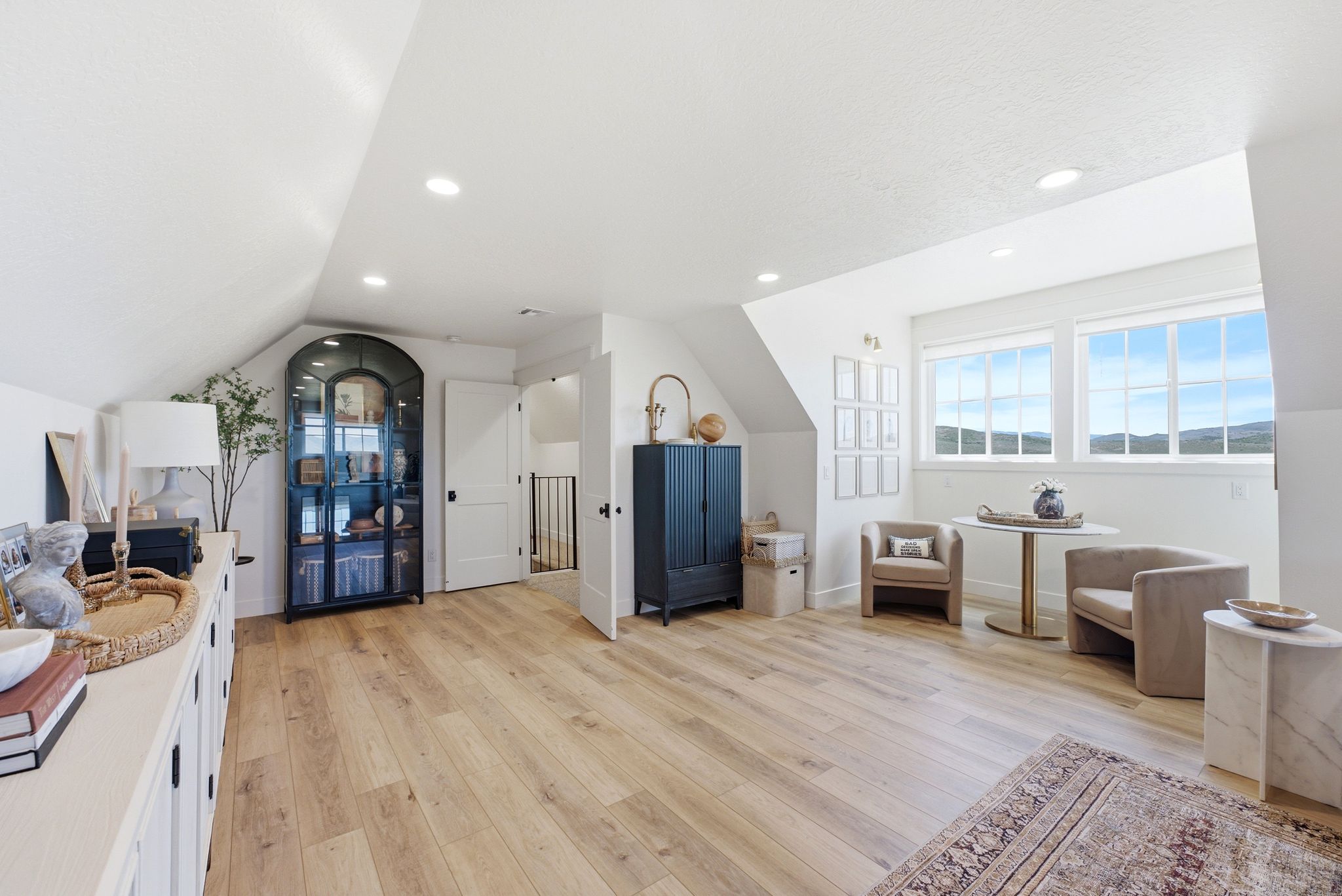 Attic living space featuring wood-finish flooring, recessed lighting, and a sloped ceiling