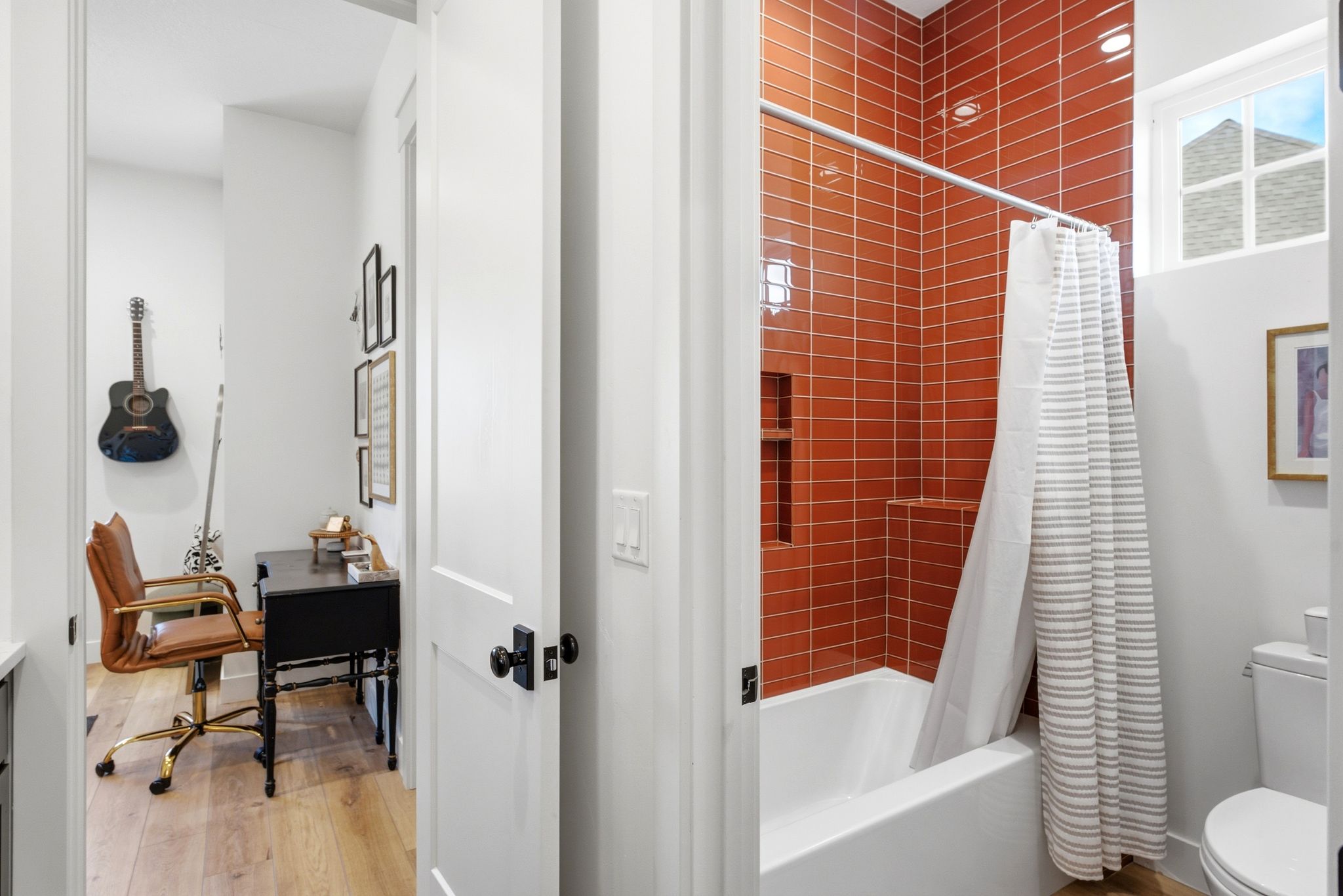 Bathroom featuring a shower/tub combination with terracotta-colored subway tile surround and integrated shelving