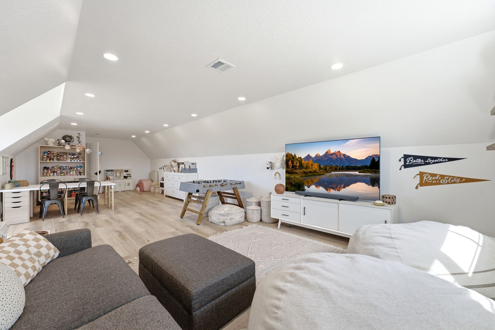 Spacious bonus room featuring sloped ceilings, recessed lighting, and wood-finish flooring