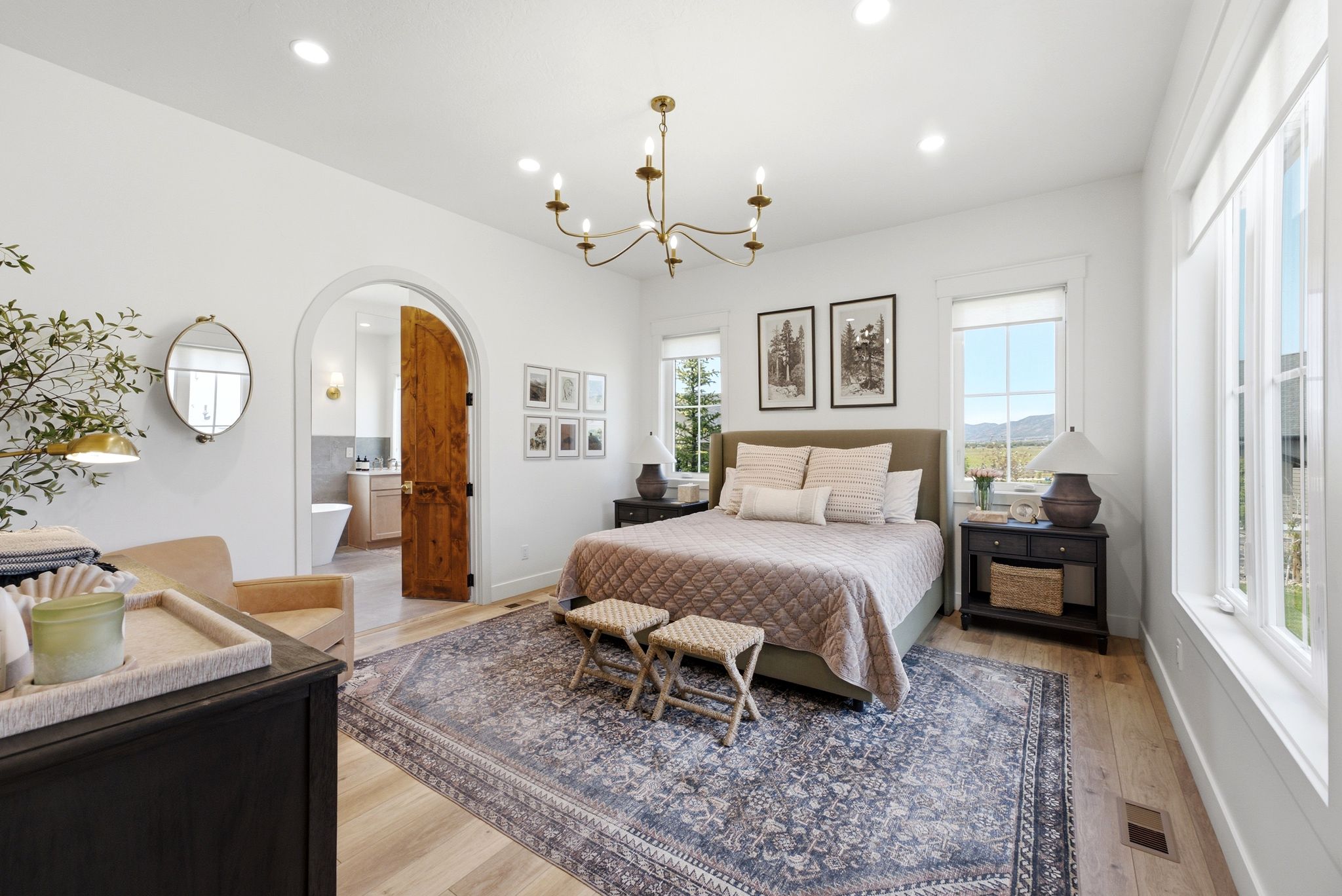 Spacious room featuring light wood-finish flooring, recessed lighting, and a chandelier fixture