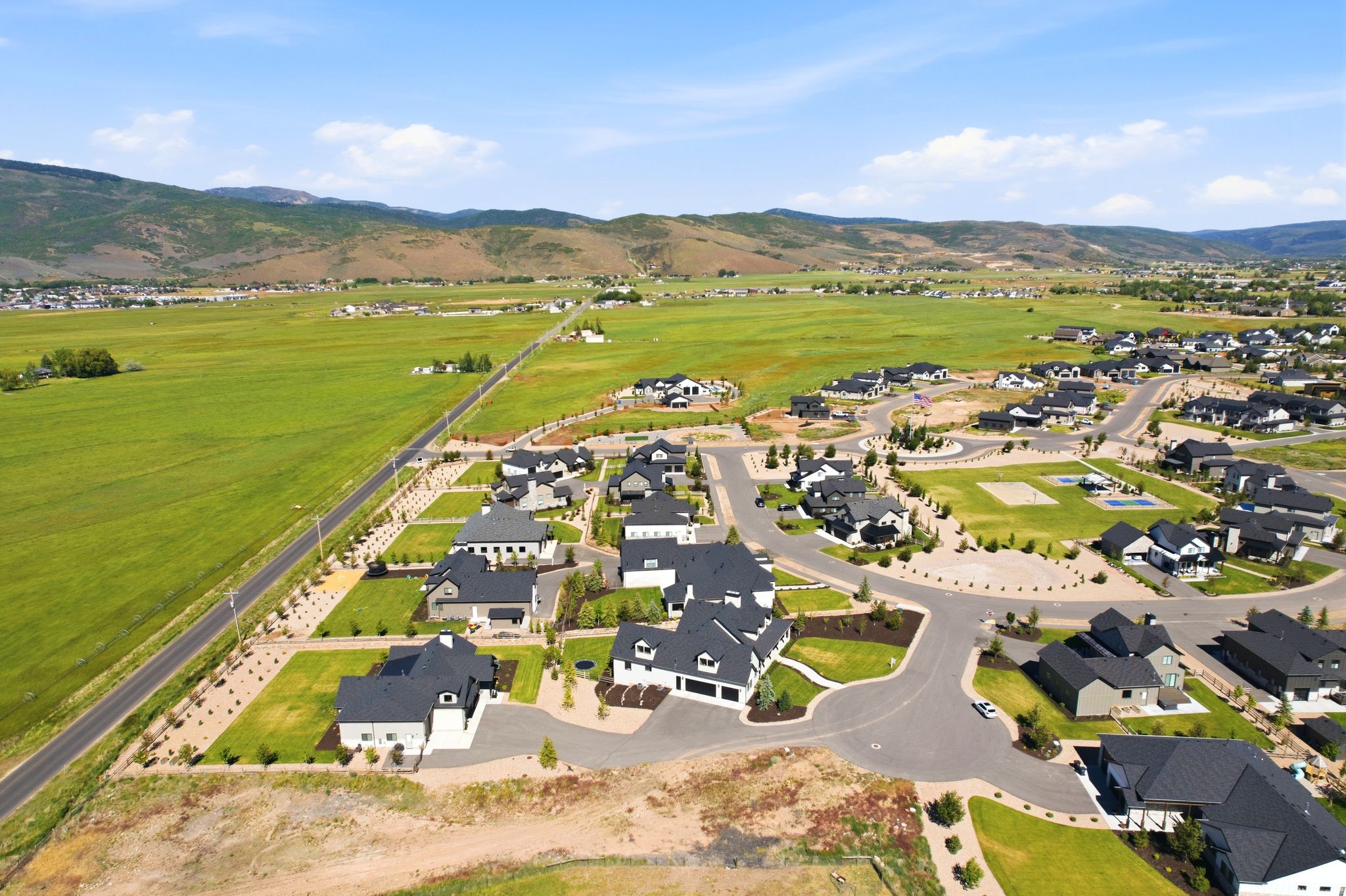 Aerial perspective showcasing a developed residential community with new construction homes