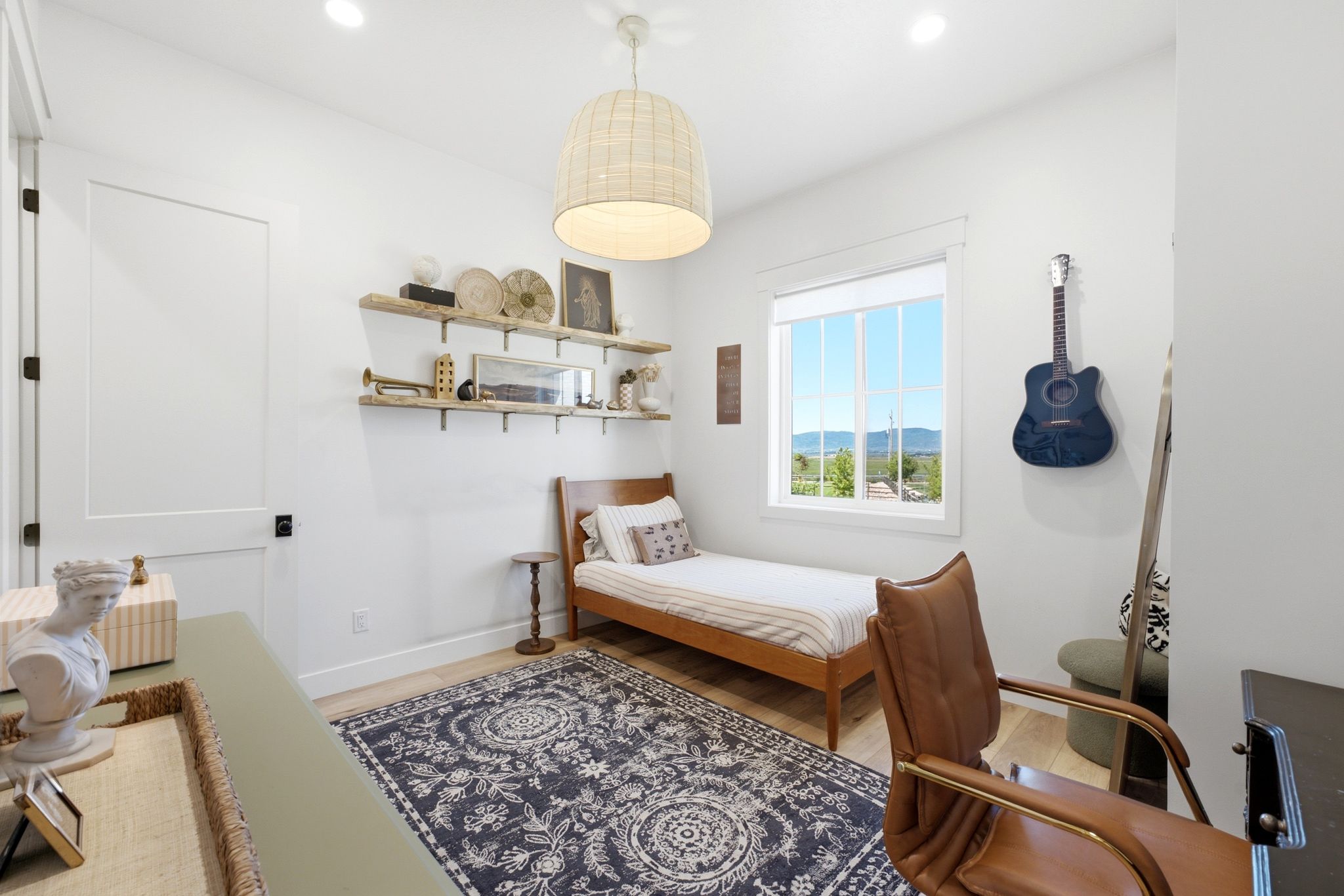 Bright room featuring wood-finish flooring, a white window frame, and recessed lighting