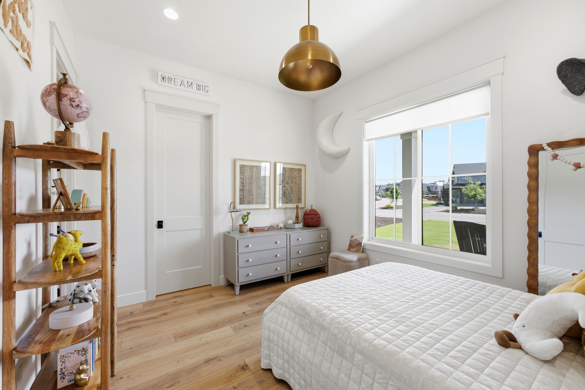 Bright interior space featuring wood-finish flooring, a large window with white trim, and recessed lighting