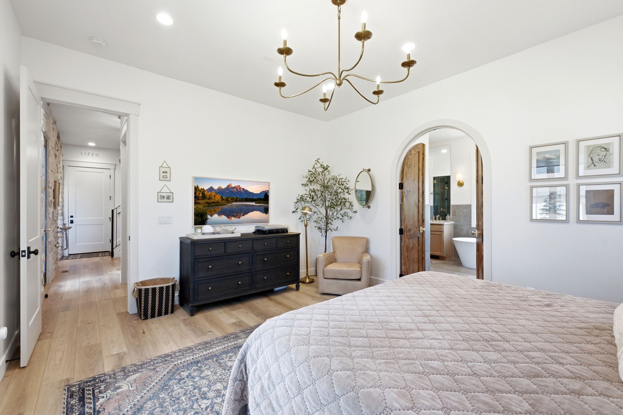 Light wood-finish flooring with a decorative area rug