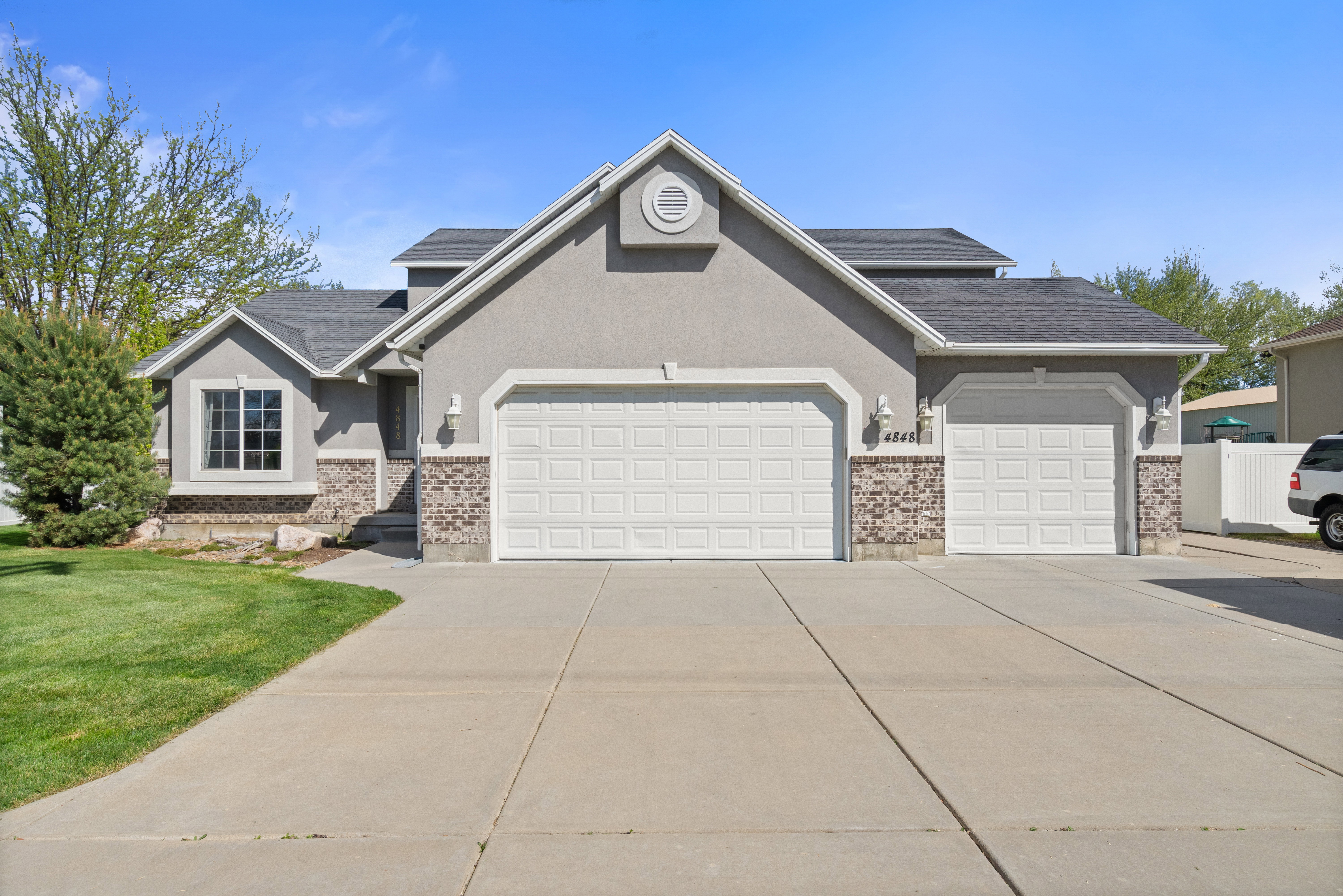Contemporary stucco exterior with stone accents