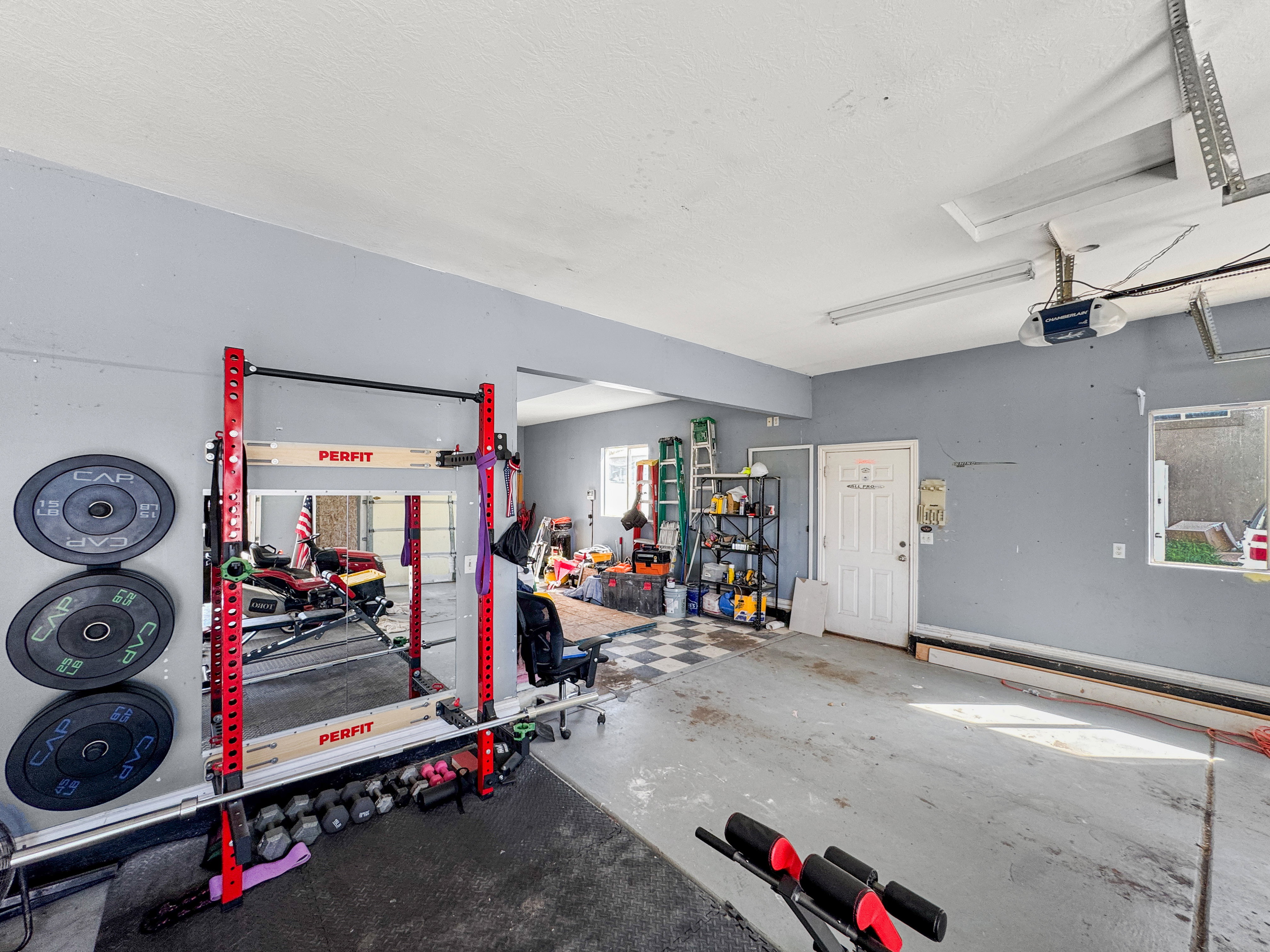 Spacious garage featuring a concrete floor, painted walls, and an overhead garage door
