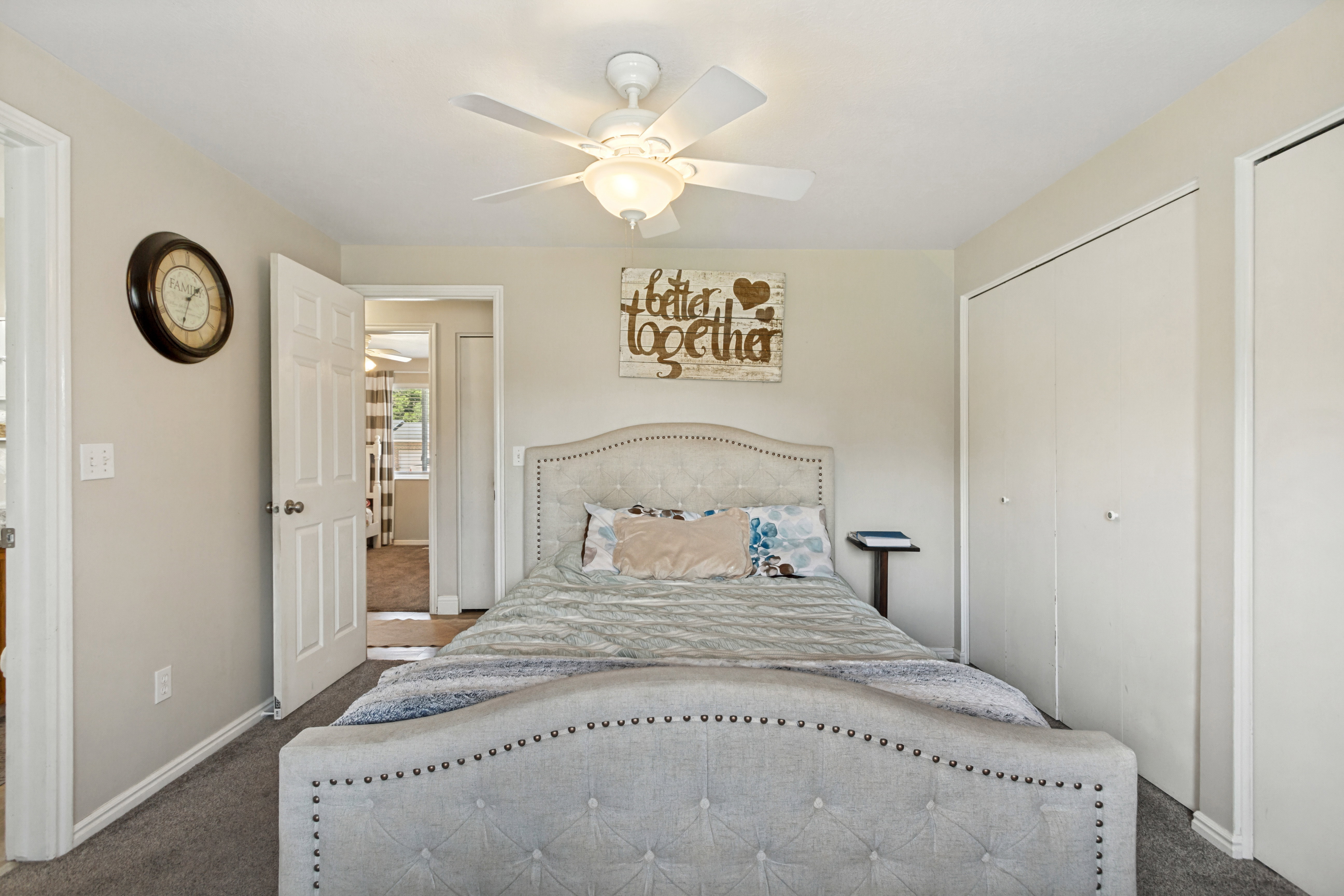 Neutral tone painted walls complement the grey carpeted flooring