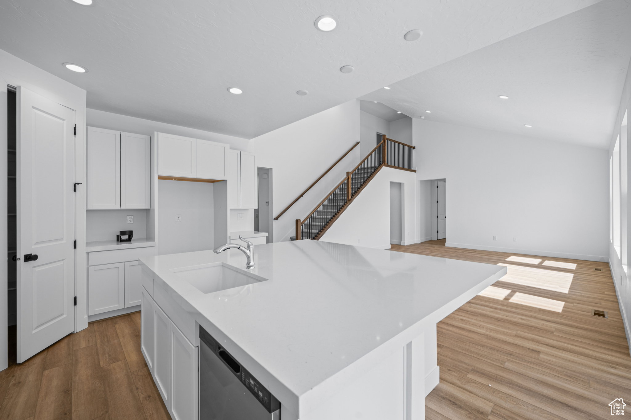 Kitchen island featuring an undermount sink and integrated dishwasher. This is not the actual home being built but a representation of the features available in this home. Colors and finishes may differ from those shown. There will be a 1/2 pony wall inst