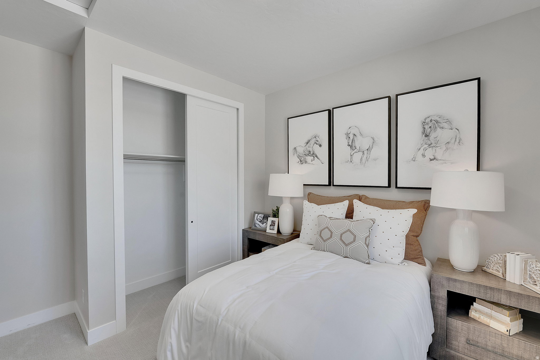 Bedroom featuring light gray wall paint, white trim, and light-toned carpet flooring. This is not the actual home being built but a representation of the features available in this home. Colors and finishes may differ from those shown.