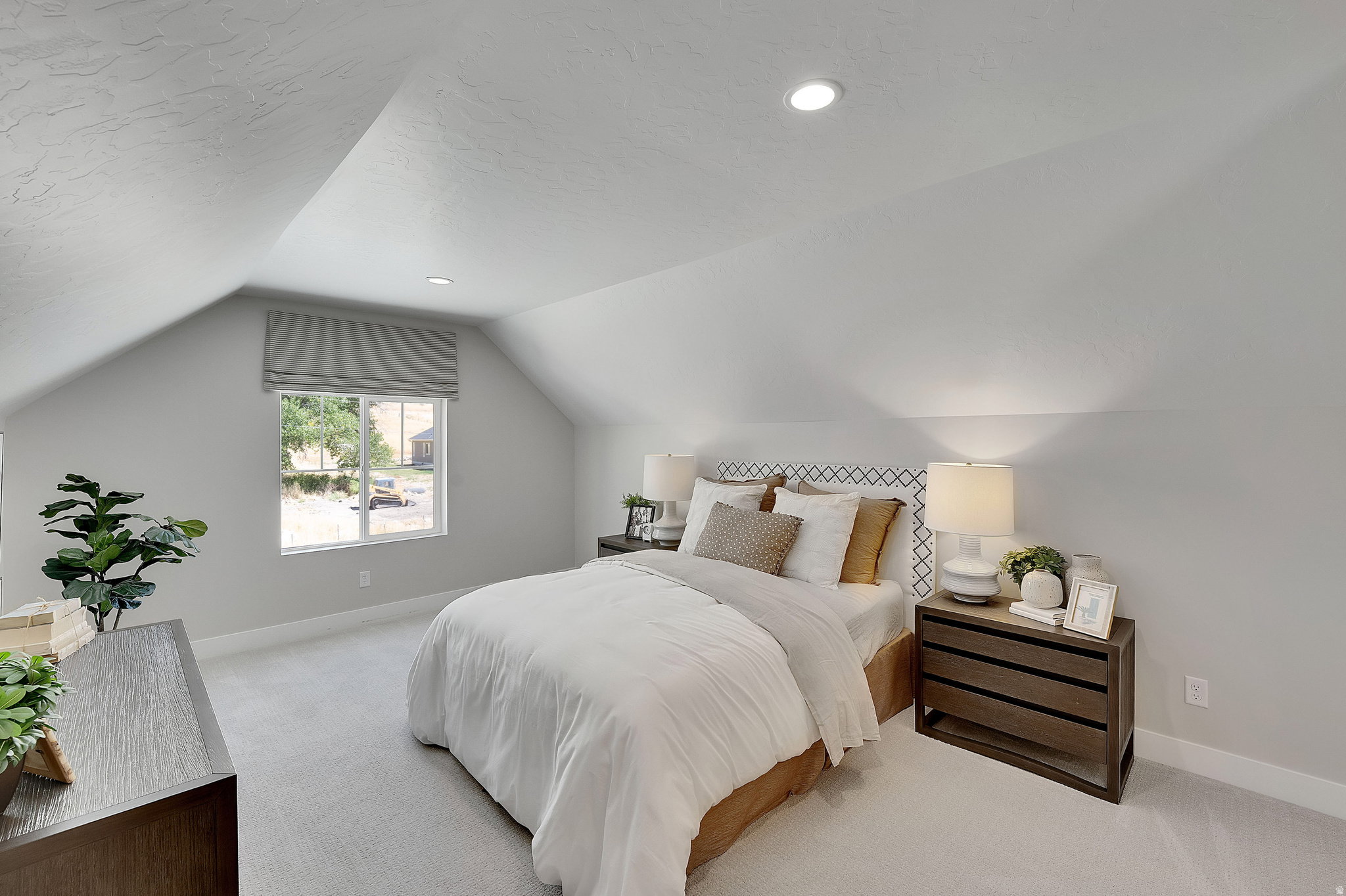 Attic room featuring a window with a roman shade, recessed lighting, and light-colored carpeting. This is not the actual home being built but a representation of the features available in this home. Colors and finishes may differ from those shown.