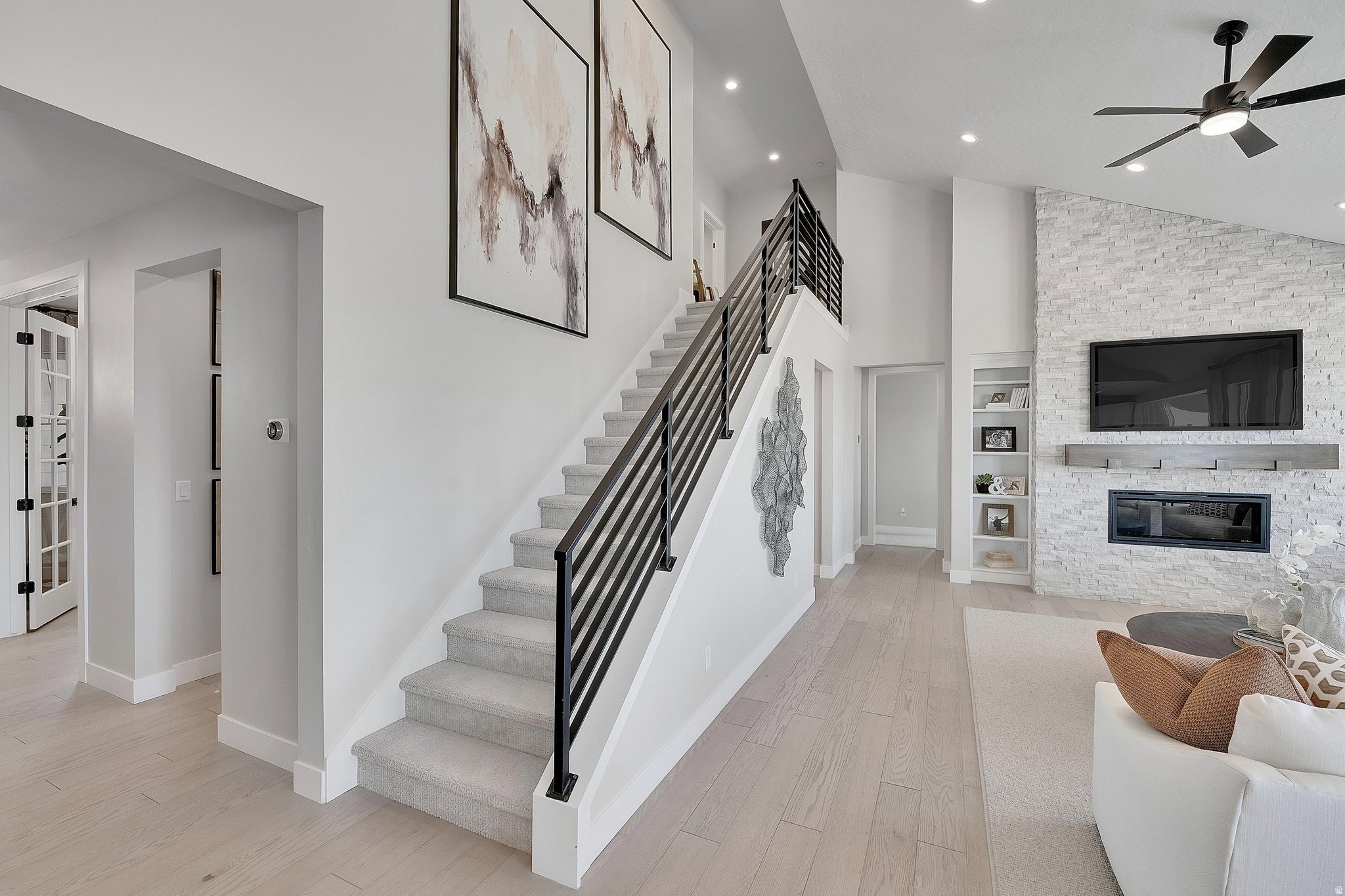 Light wood-finish flooring extending from the entryway into the living area. This is not the actual home being built but a representation of the features available in this home. Colors and finishes may differ from those shown.
