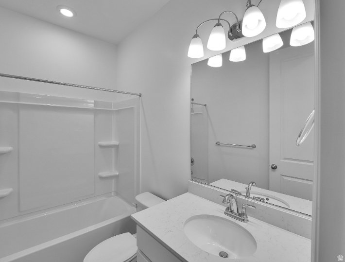 Bathroom vanity featuring a single basin sink, chrome faucet, and expansive wall-mounted mirror. This is not the actual home being built but a representation of the features available in this home. Colors and finishes may differ from those shown. This is