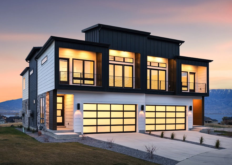 Contemporary exterior featuring a multi-tone facade with dark vertical siding, light horizontal siding, and stone accents