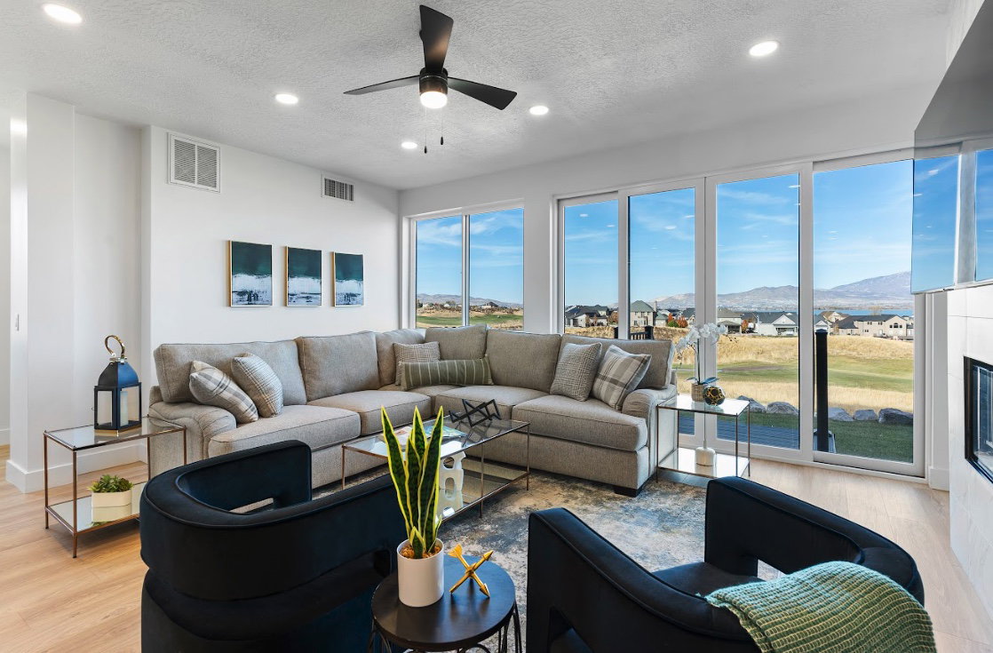Open-concept living area featuring an expansive window wall with mountain and landscape scenery