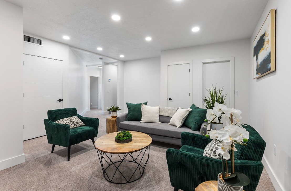 Bright living space featuring recessed lighting and light-toned carpeting