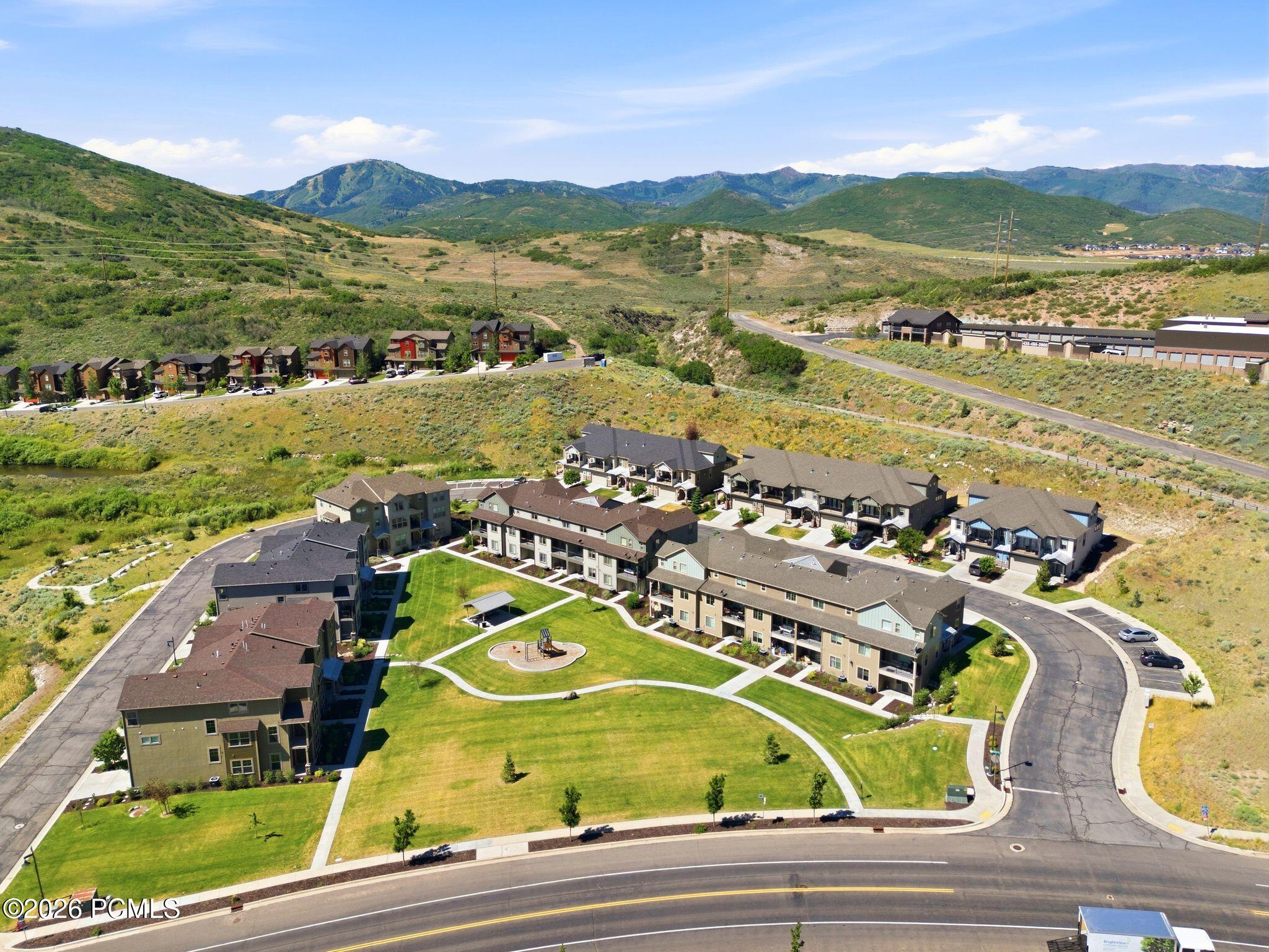 Residential community featuring a central green space with paths and landscaping