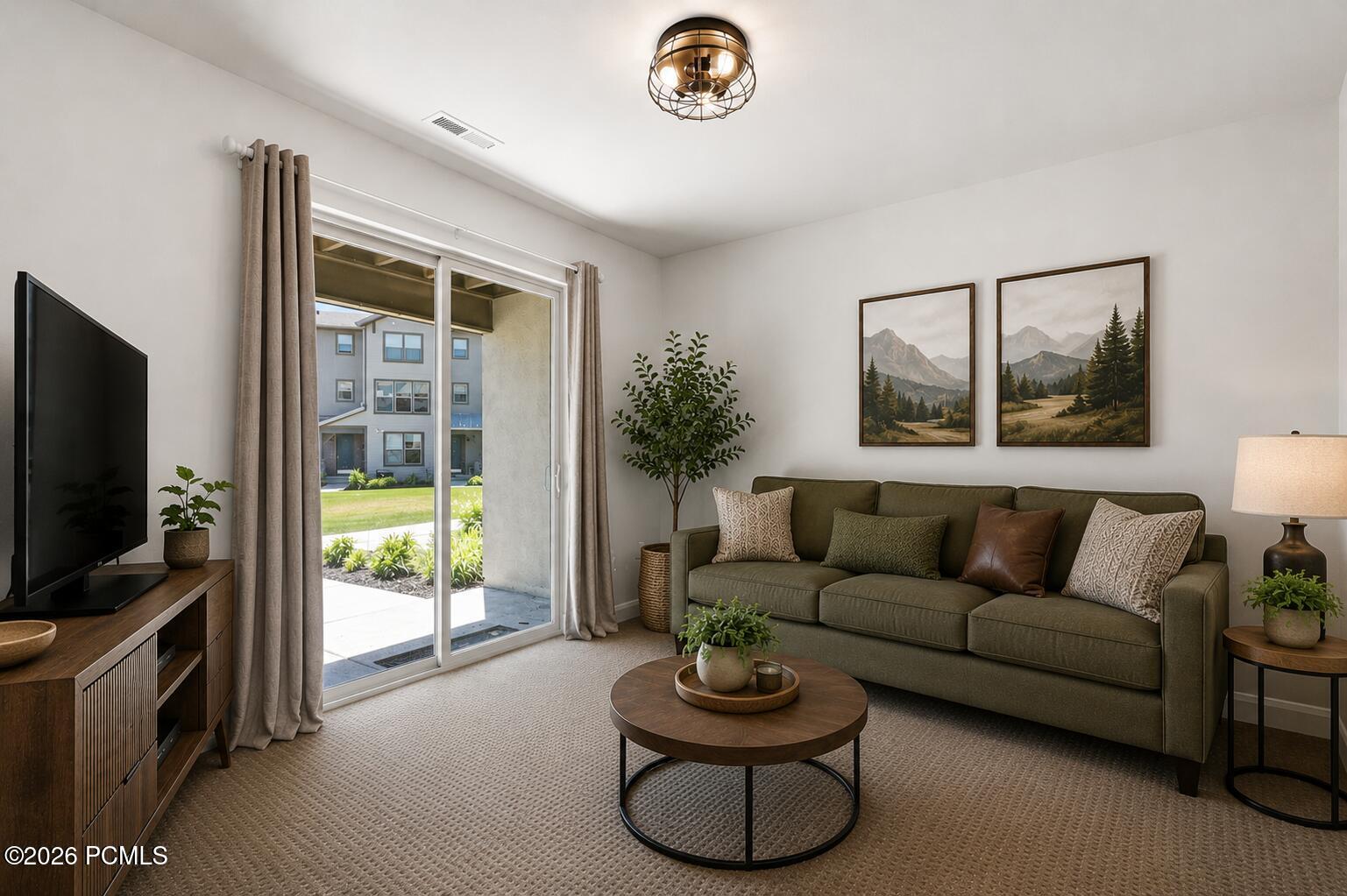 Carpeted living area featuring a sliding glass door leading to an outdoor patio