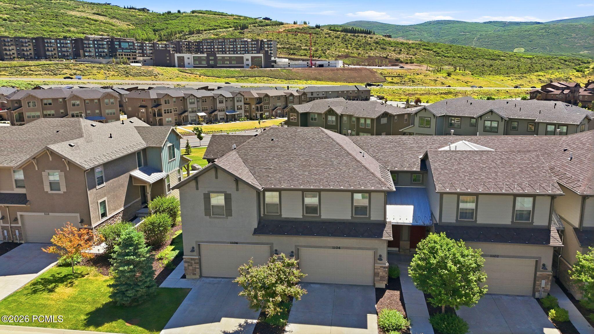 Contemporary townhome community with a hillside backdrop