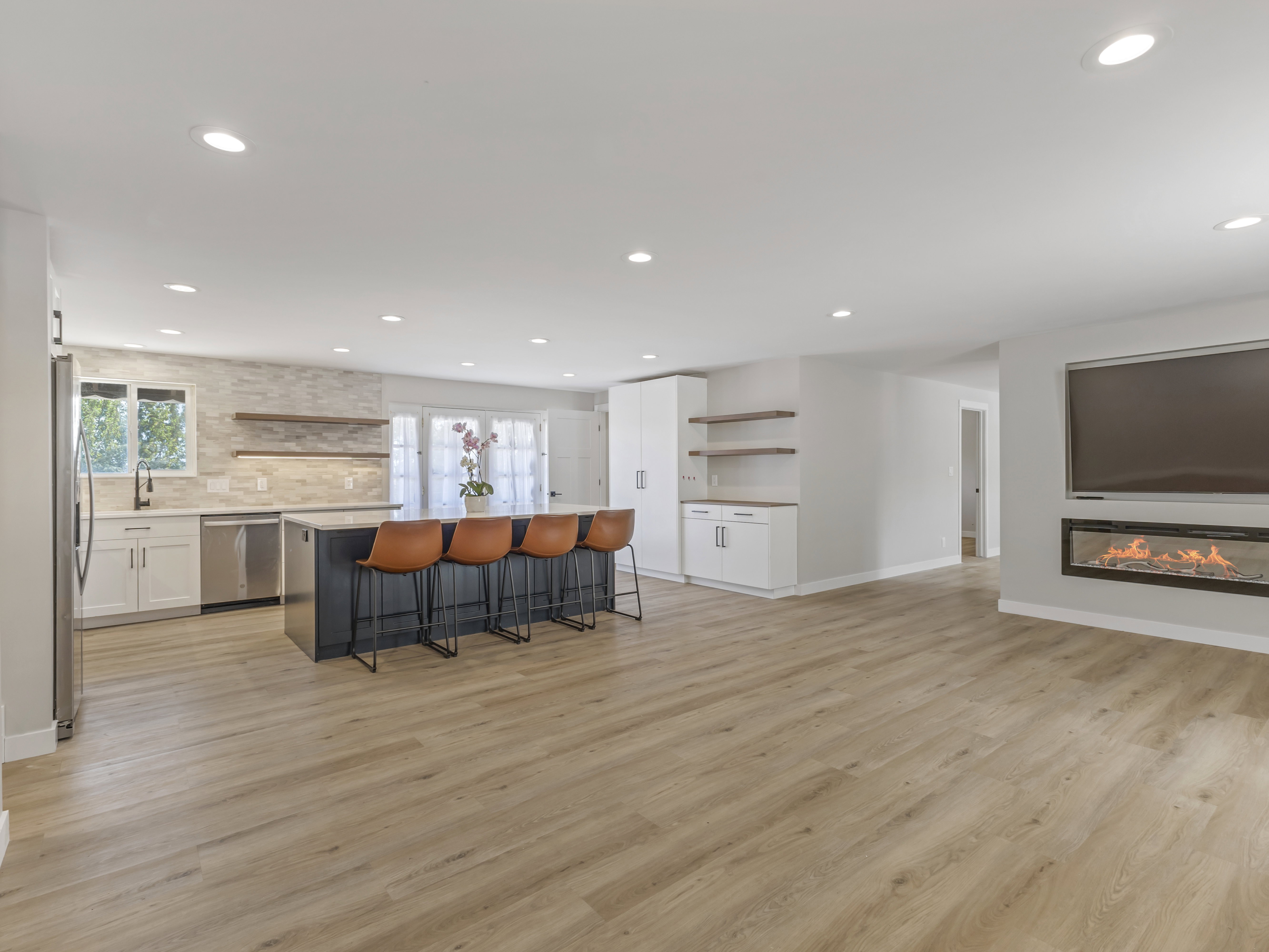 Open-concept living space with wood-finish flooring