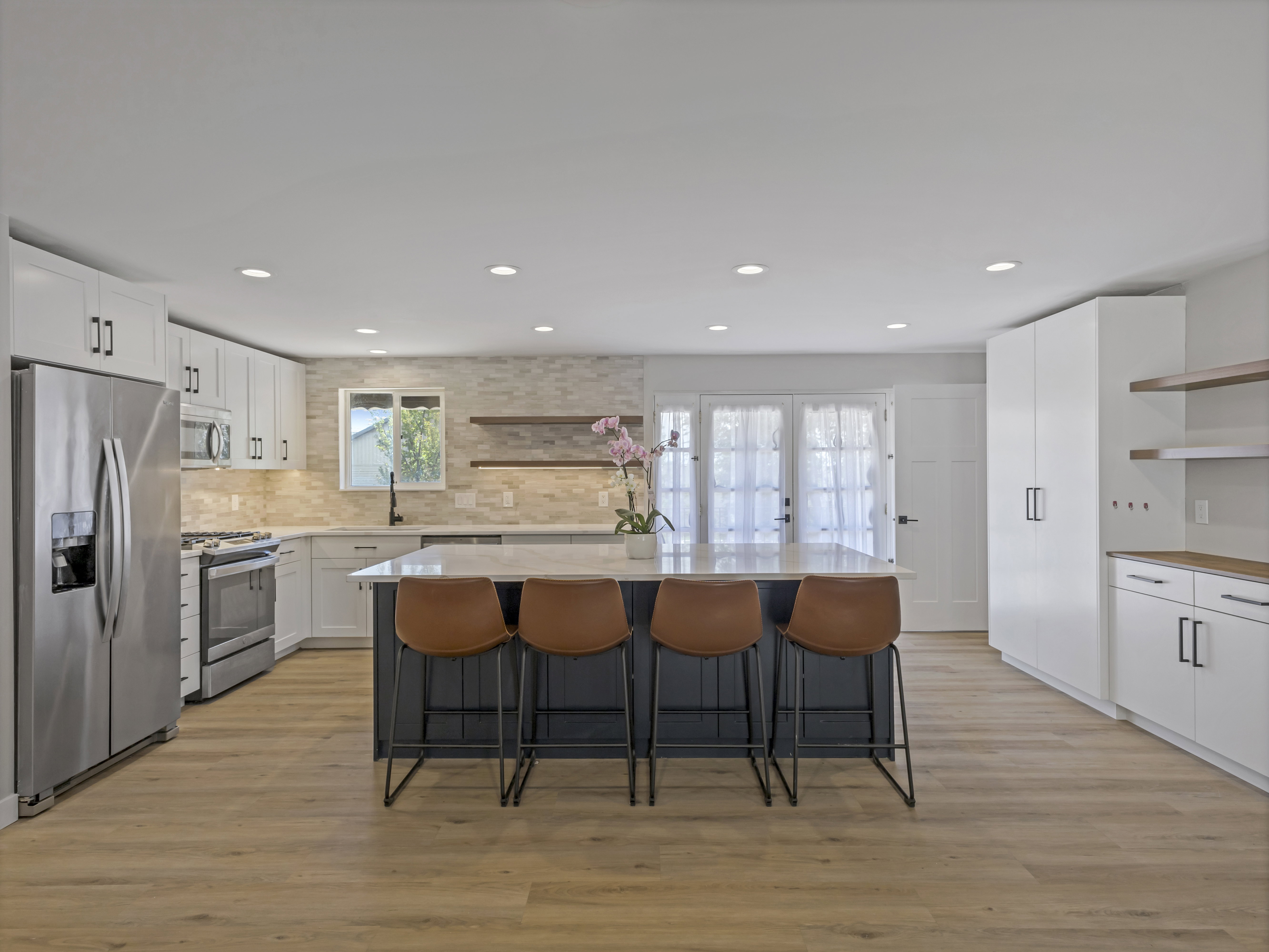 Modern kitchen with a central island featuring a light-toned countertop