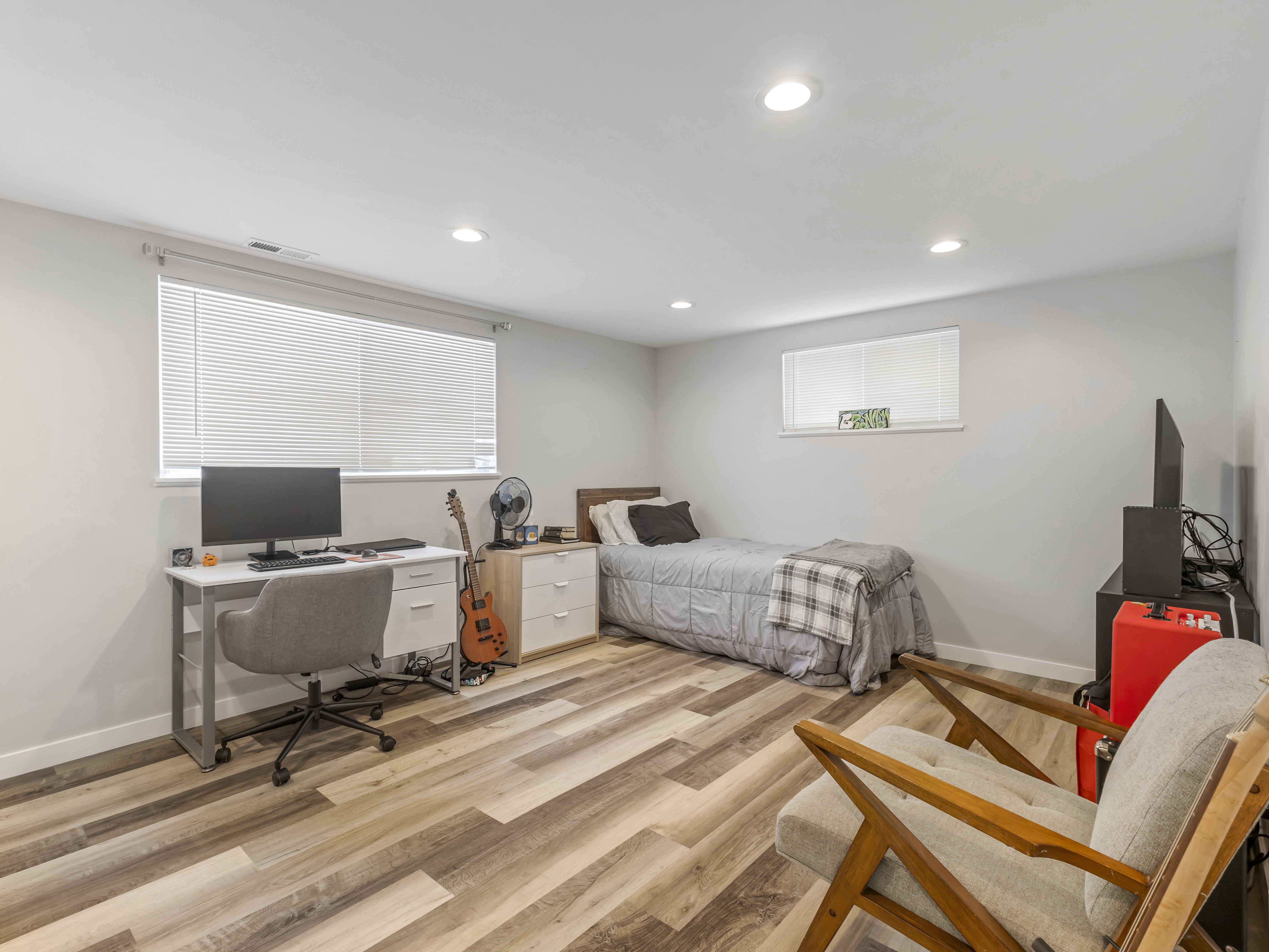Neutral gray walls with recessed lighting and wood-finish flooring