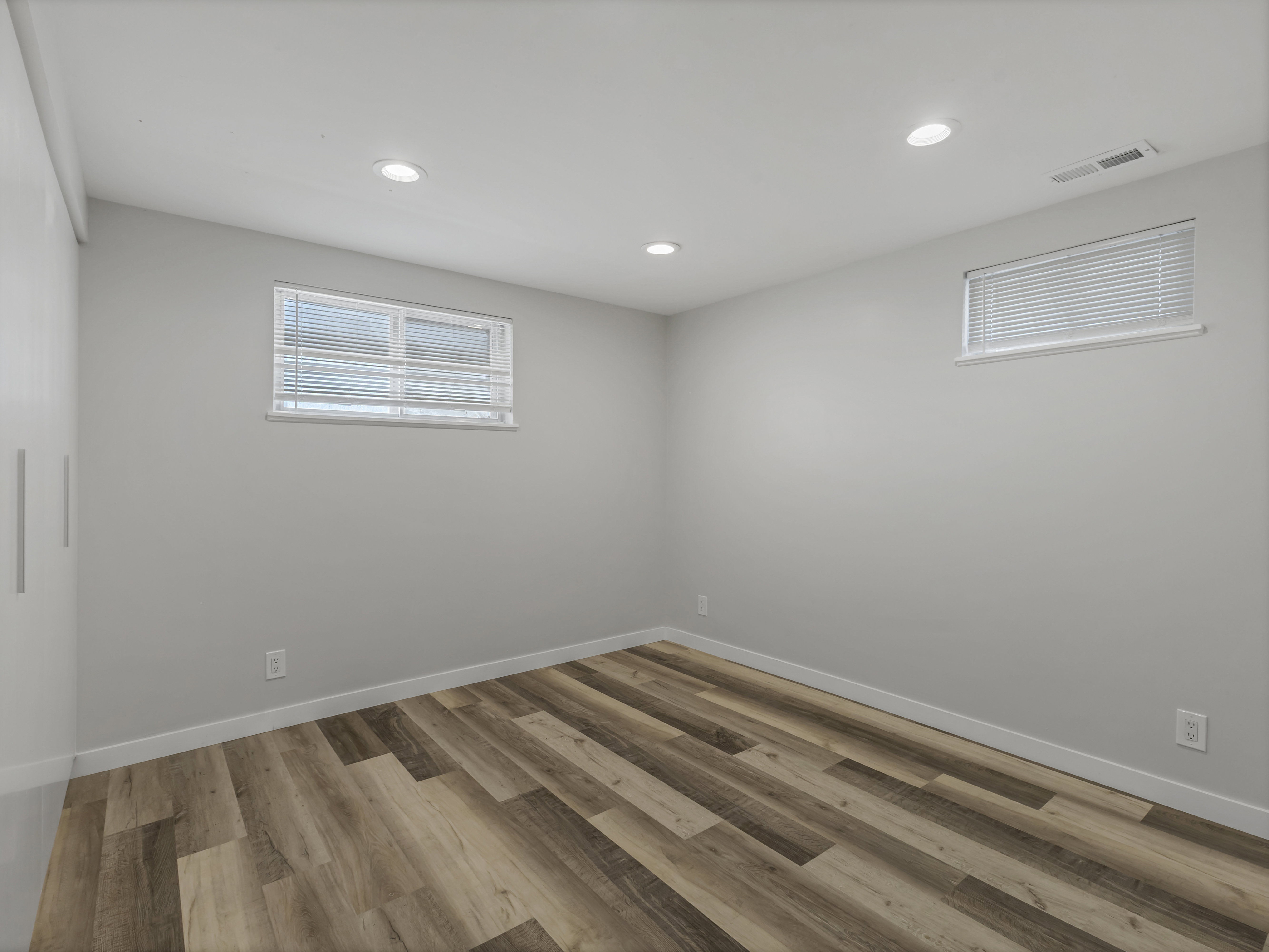 Room featuring wood-finish flooring and neutral wall tones