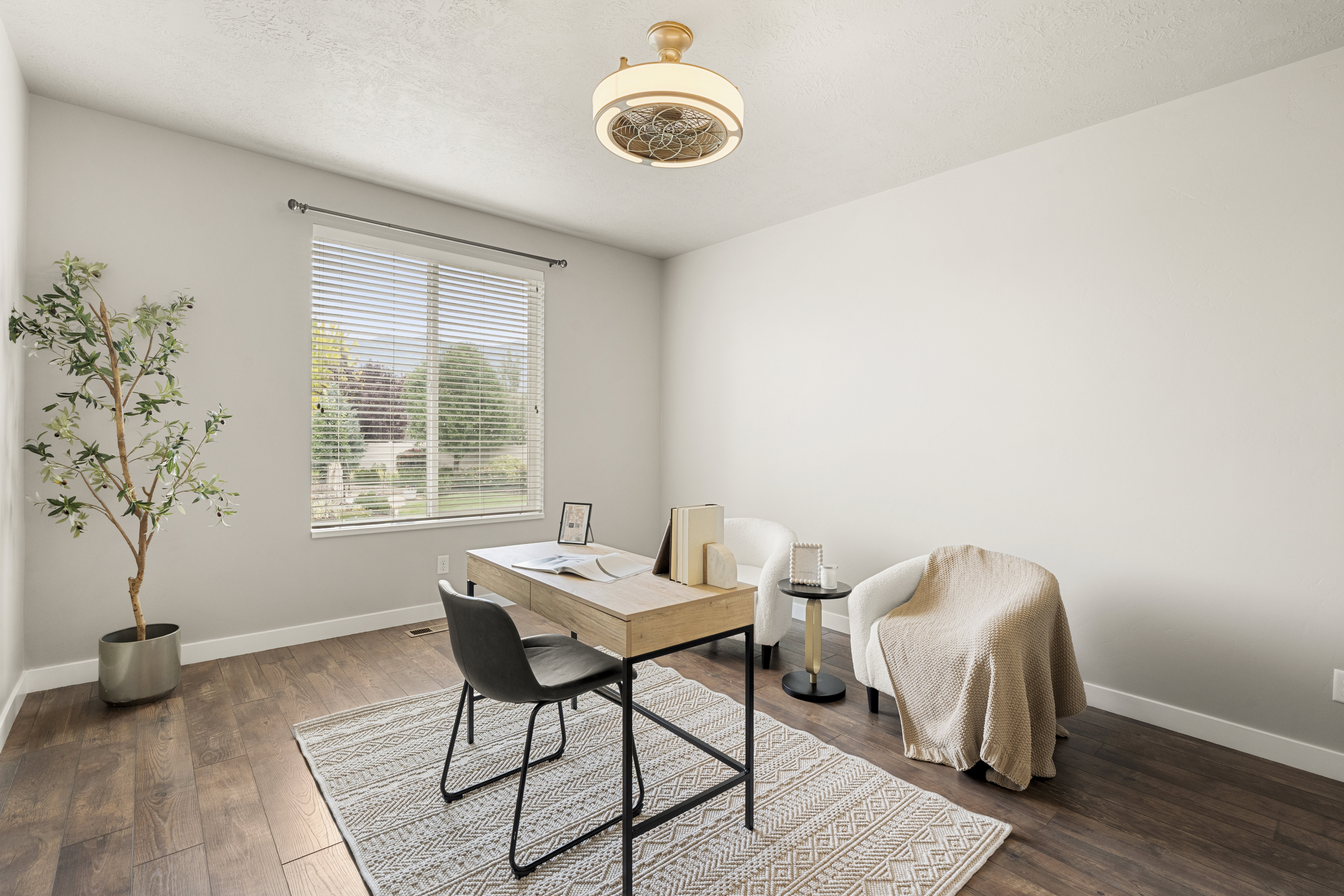 Room featuring wood-finish flooring, a large window with blinds, and a built-in ceiling light fixture