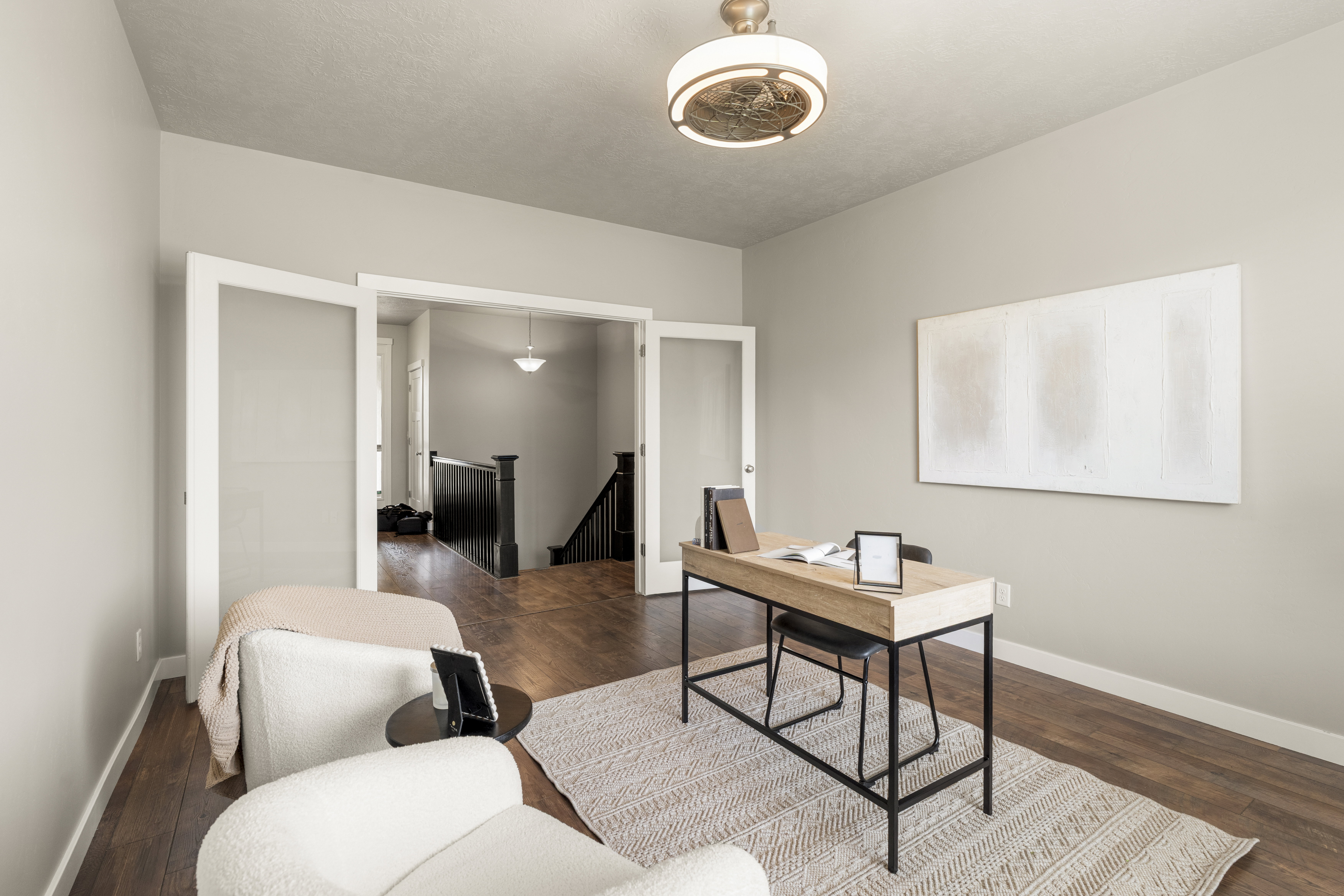 Room with wood-finish flooring and light-toned walls
