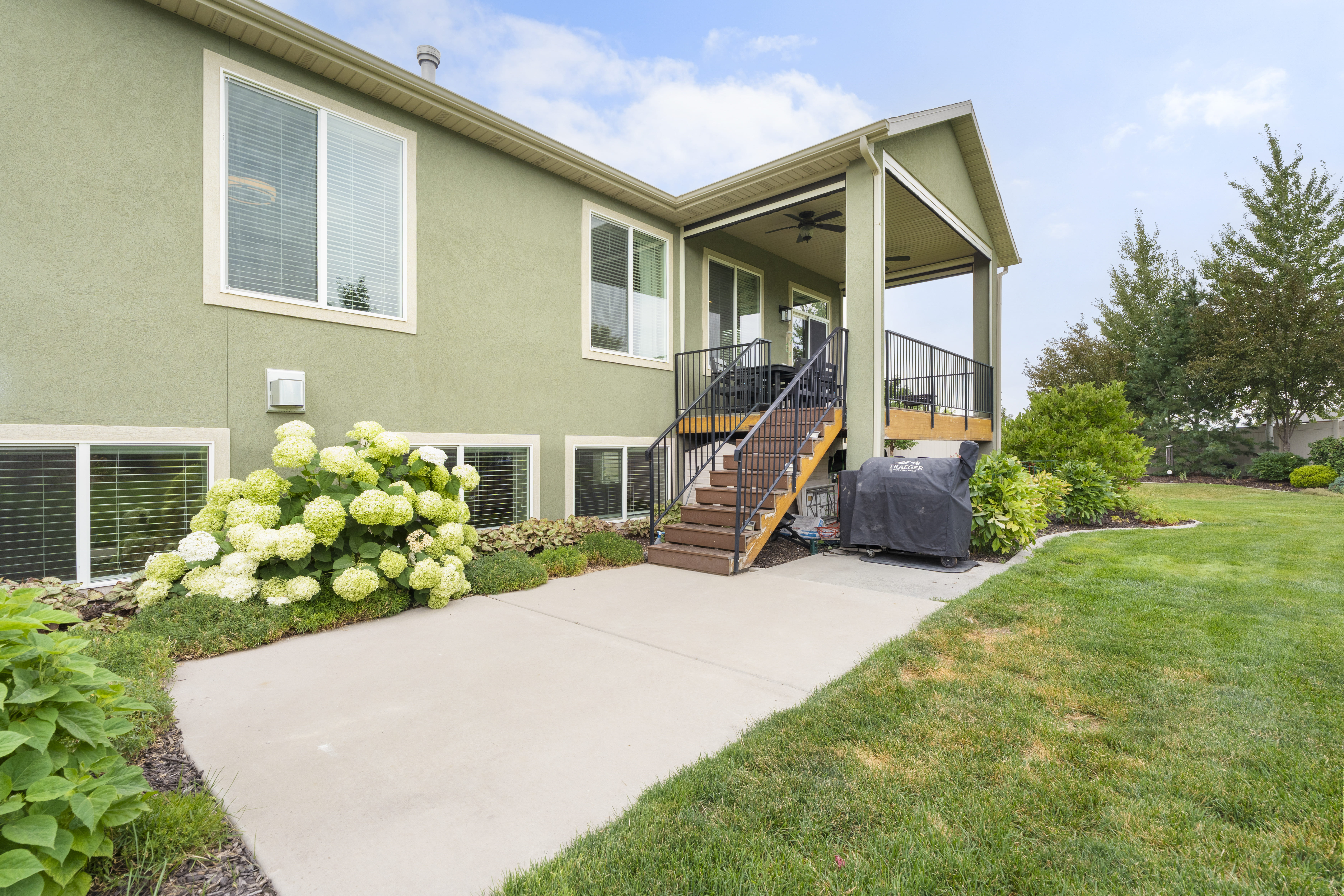 Exterior featuring a covered patio, composite deck, and concrete patio