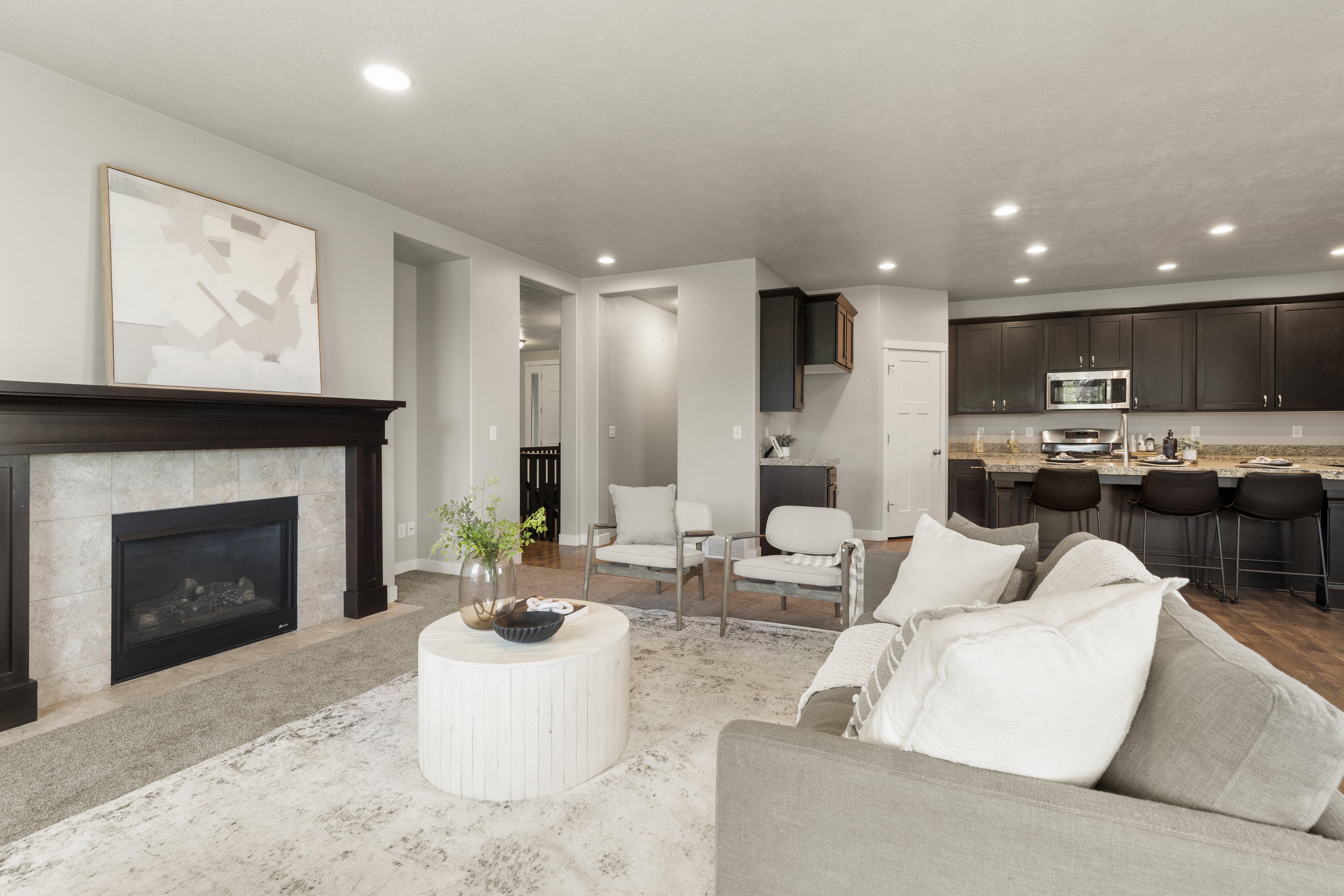 Living area featuring a fireplace with a dark wood mantel and tile surround