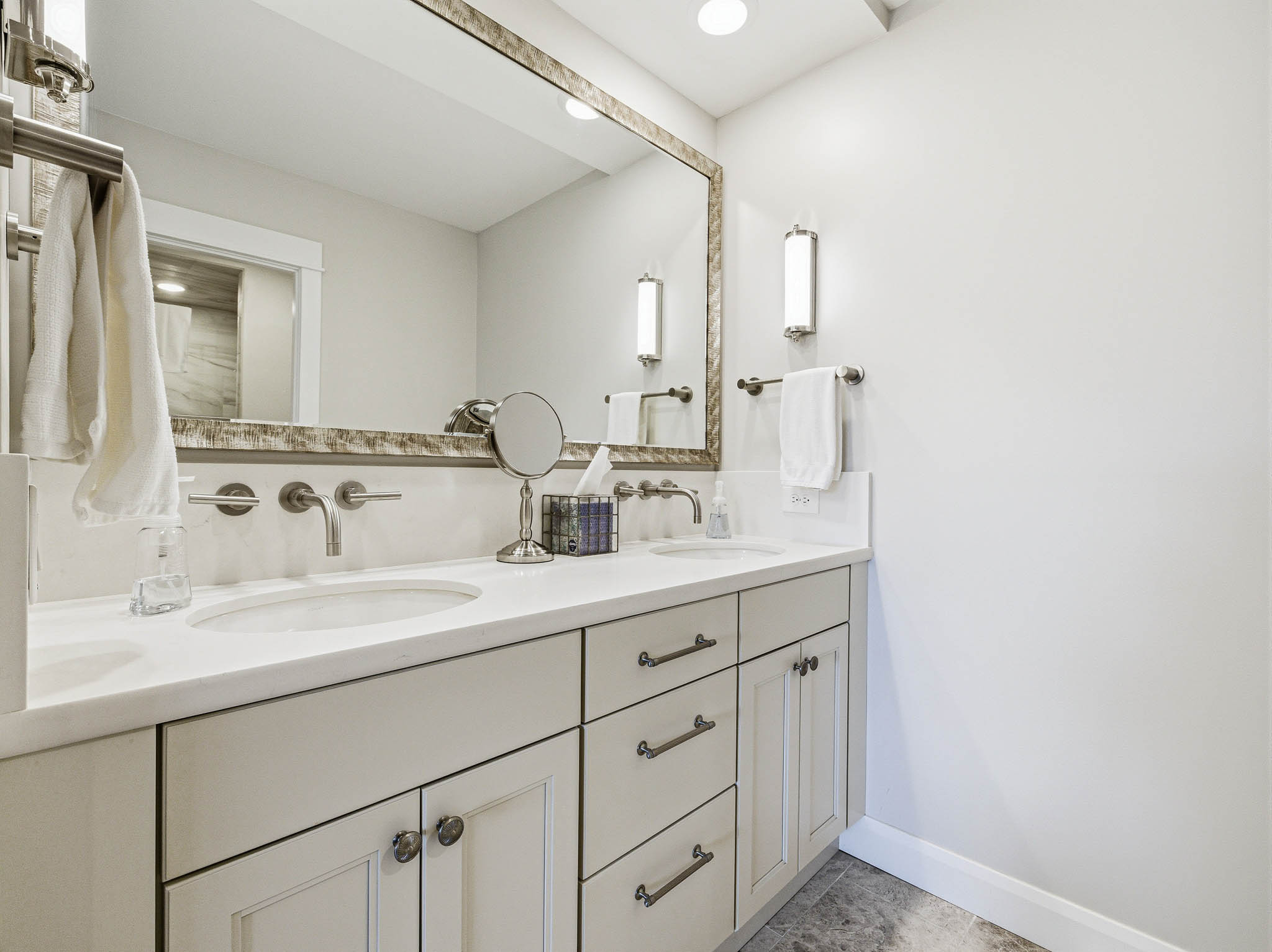 Dual vanity with undermount sinks and wall-mounted faucets