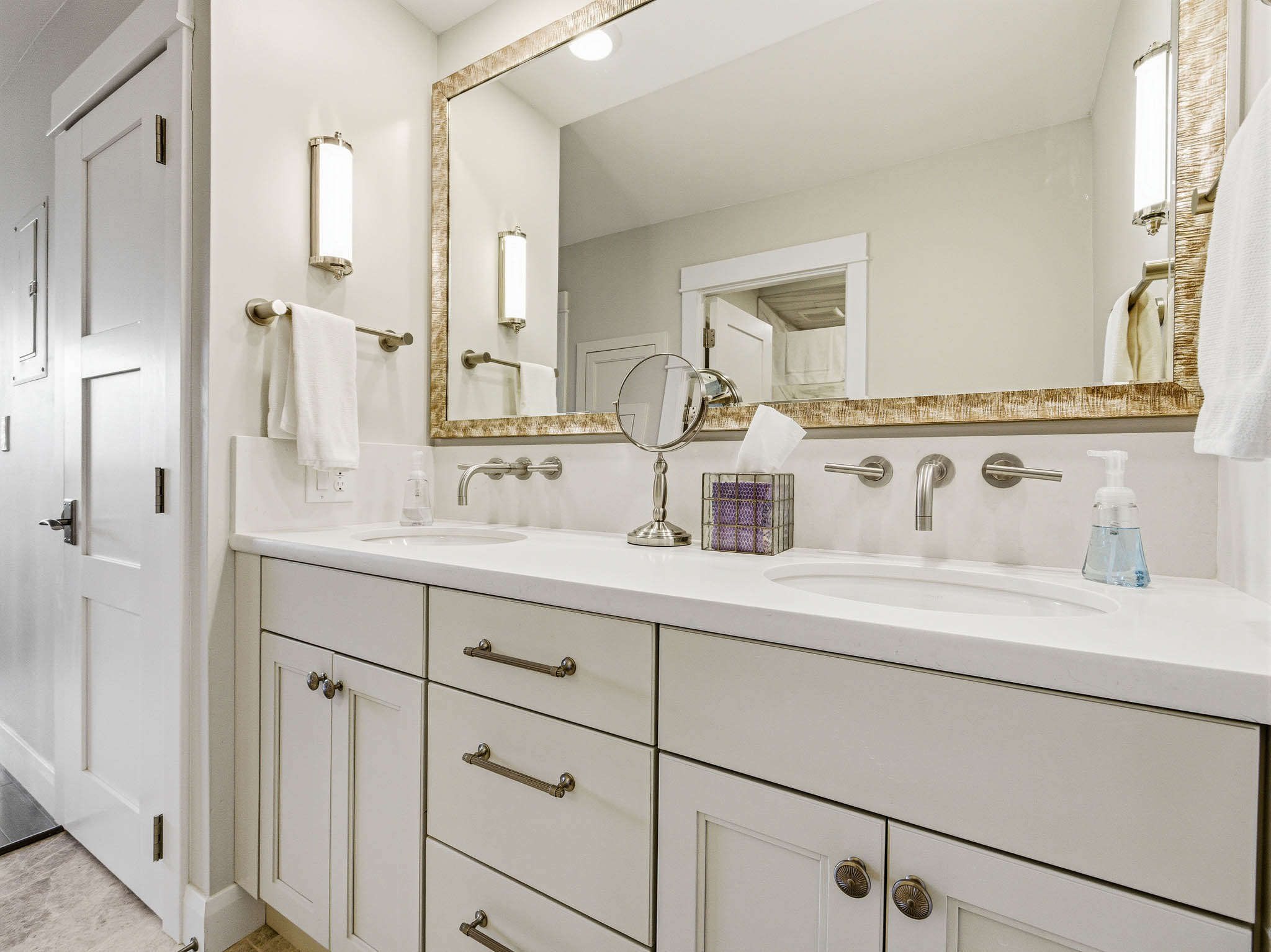 Double vanity featuring wall-mounted faucets and integrated sinks