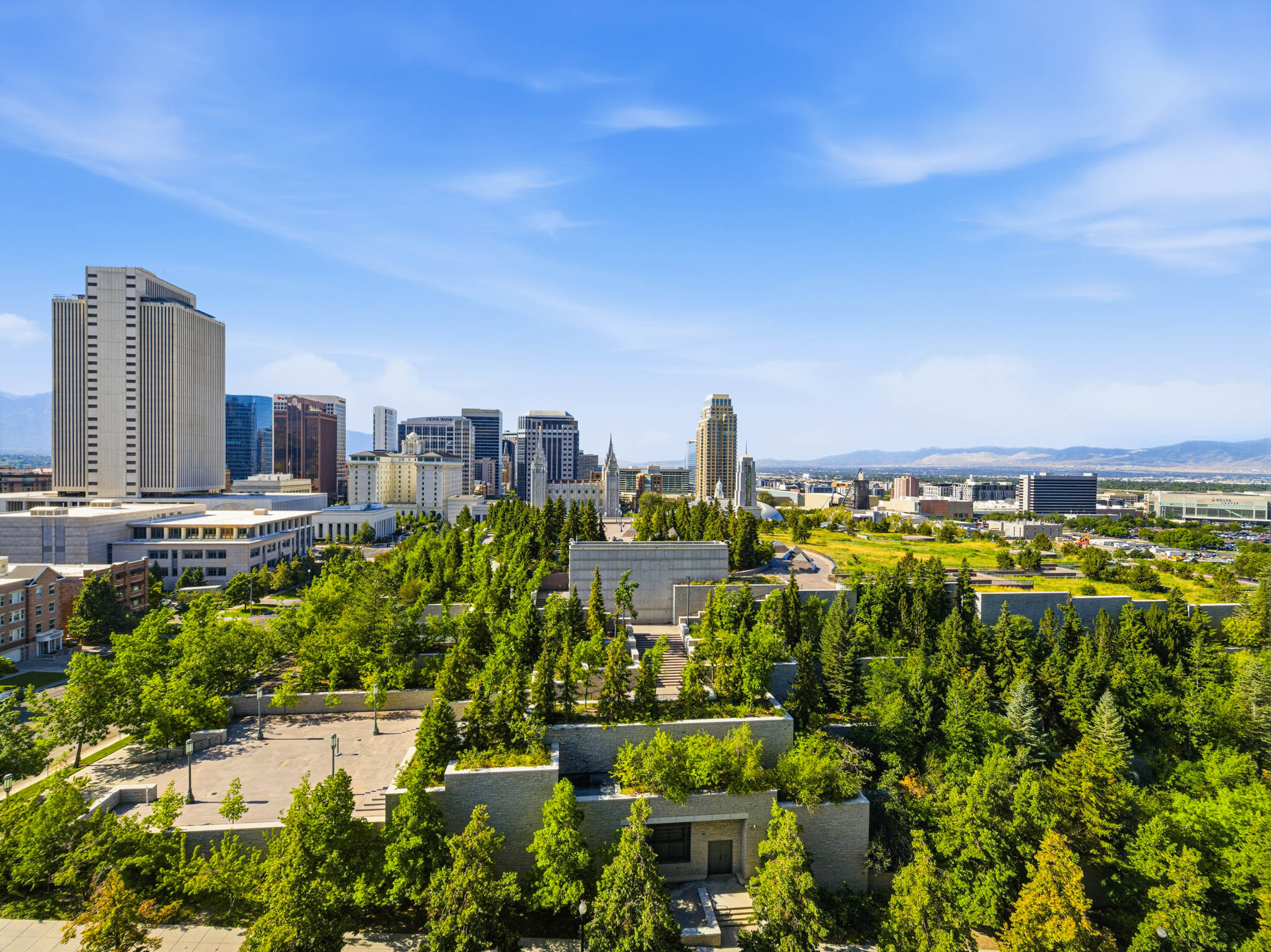 Urban skyline featuring multiple high-rise buildings and surrounding green spaces