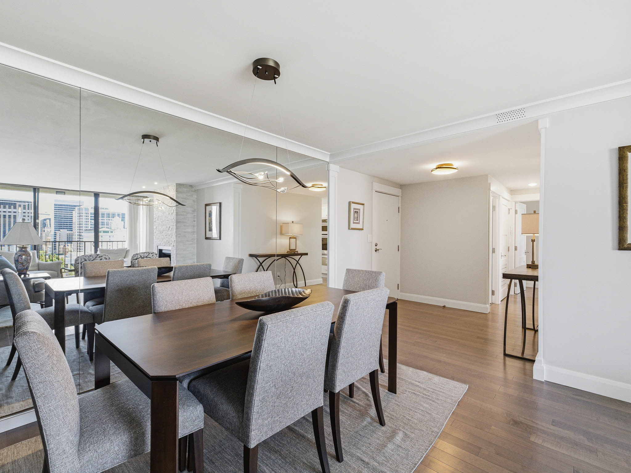 Dining area featuring dark wood-finish flooring and crown molding